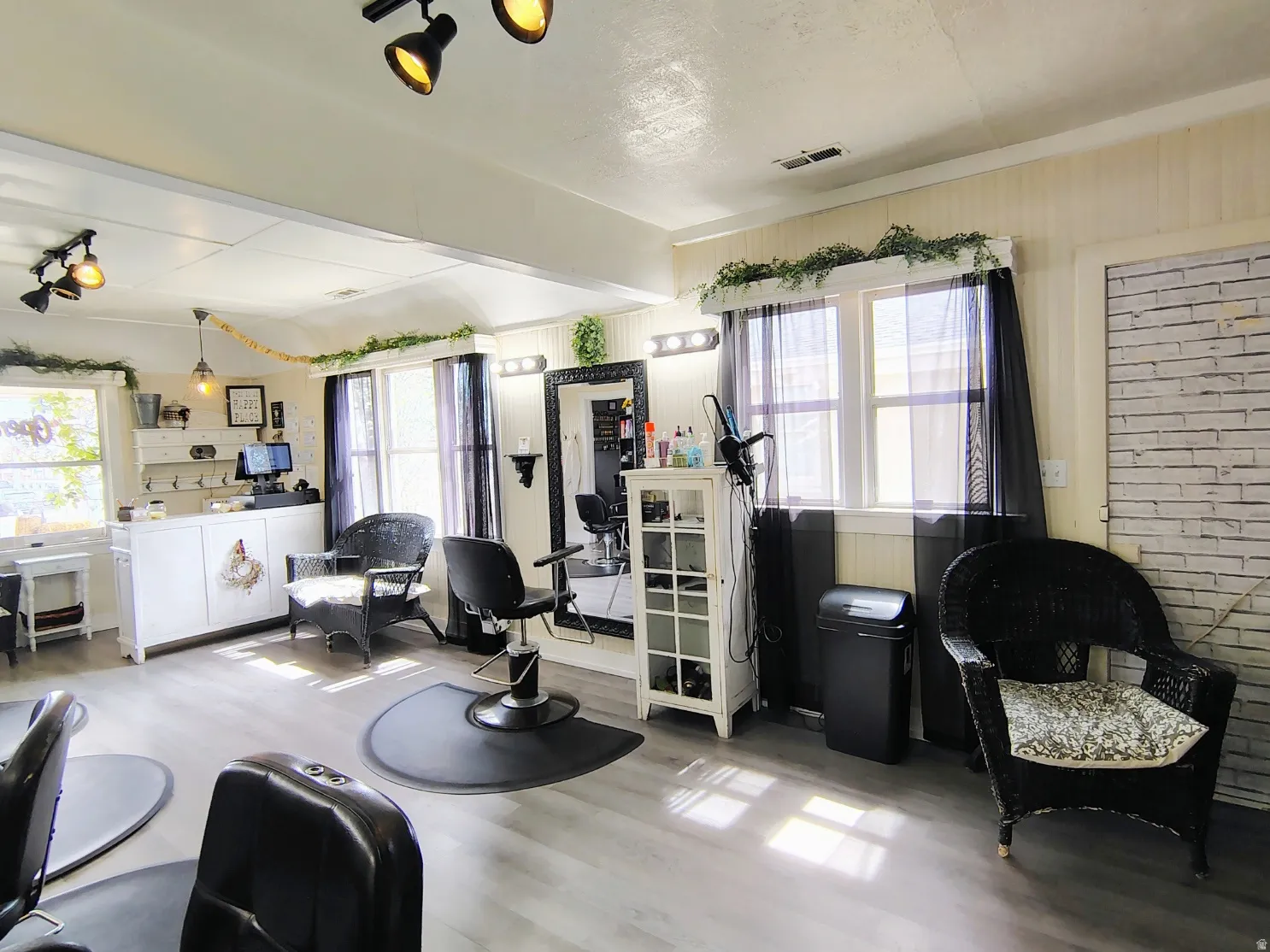 Great Room with light LVP flooring and arched walkways