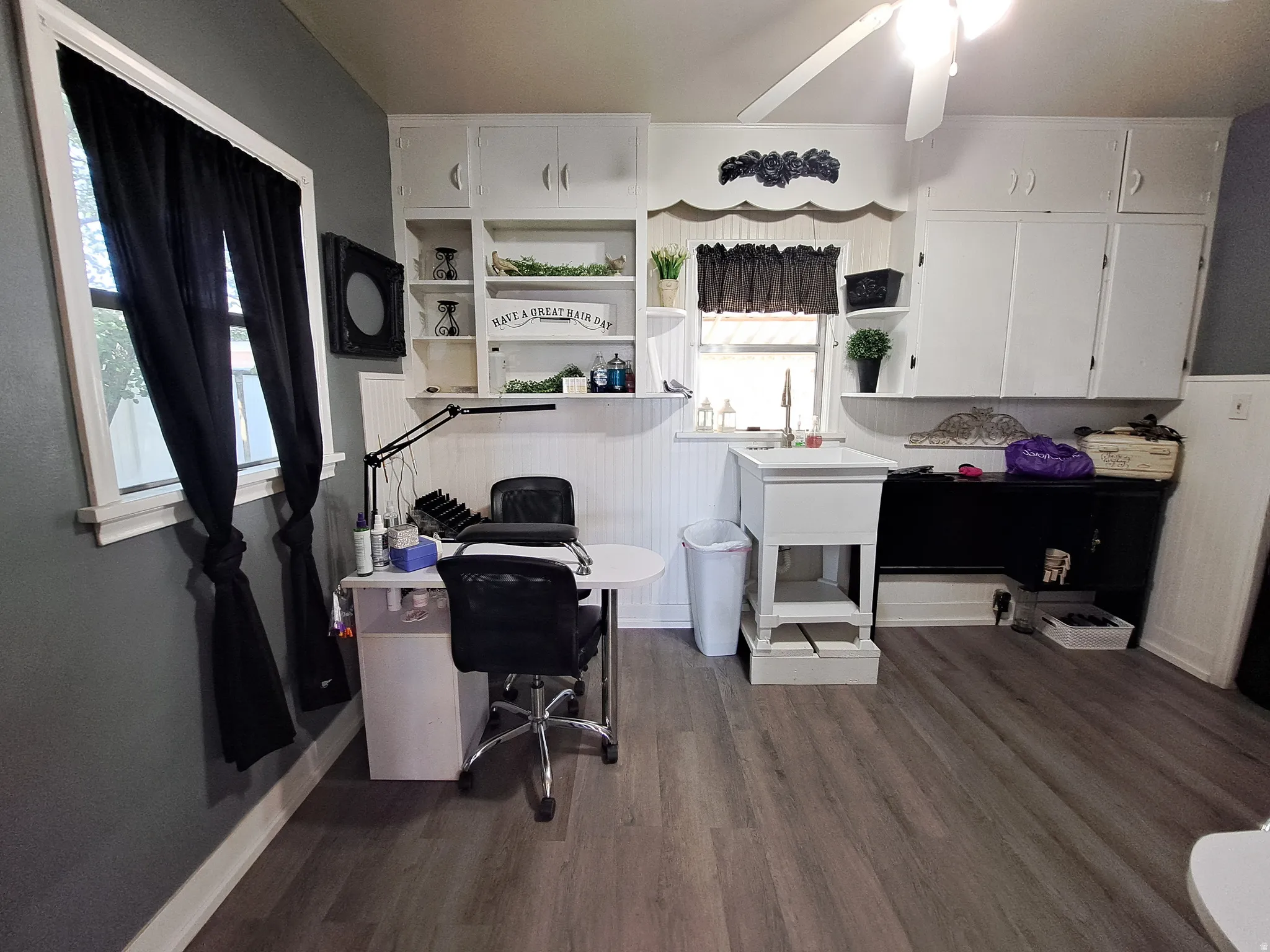 Space featuring dark wood-style floors and ceiling fan