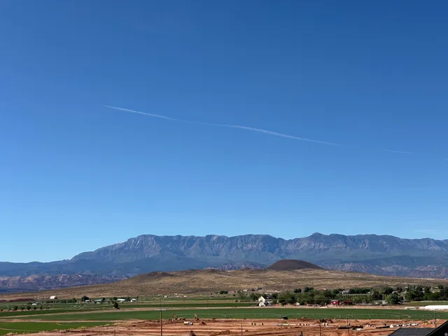 View of mountain backdrop with rural landscape