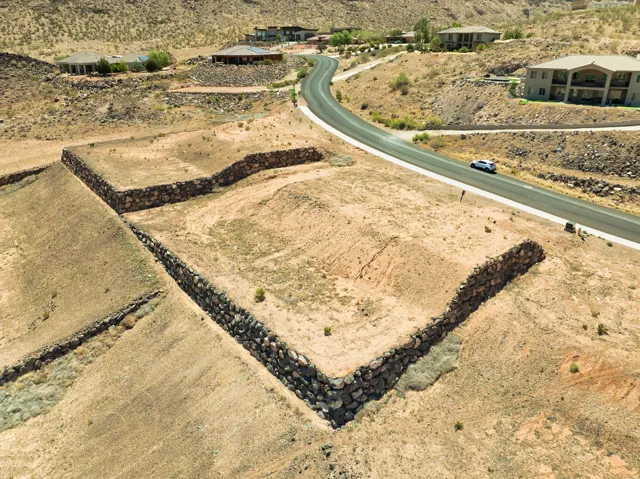Terraced property featuring stone retaining walls and direct road frontage