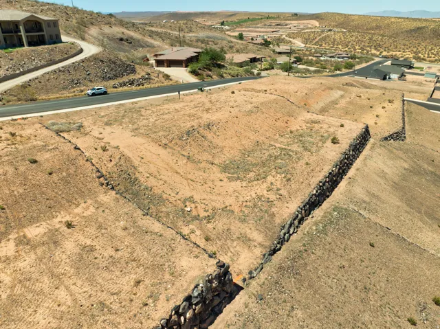 Terraced lot featuring stone retaining walls and surrounding desert landscaping