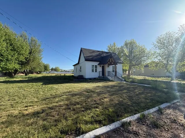 View of property exterior featuring a lawn