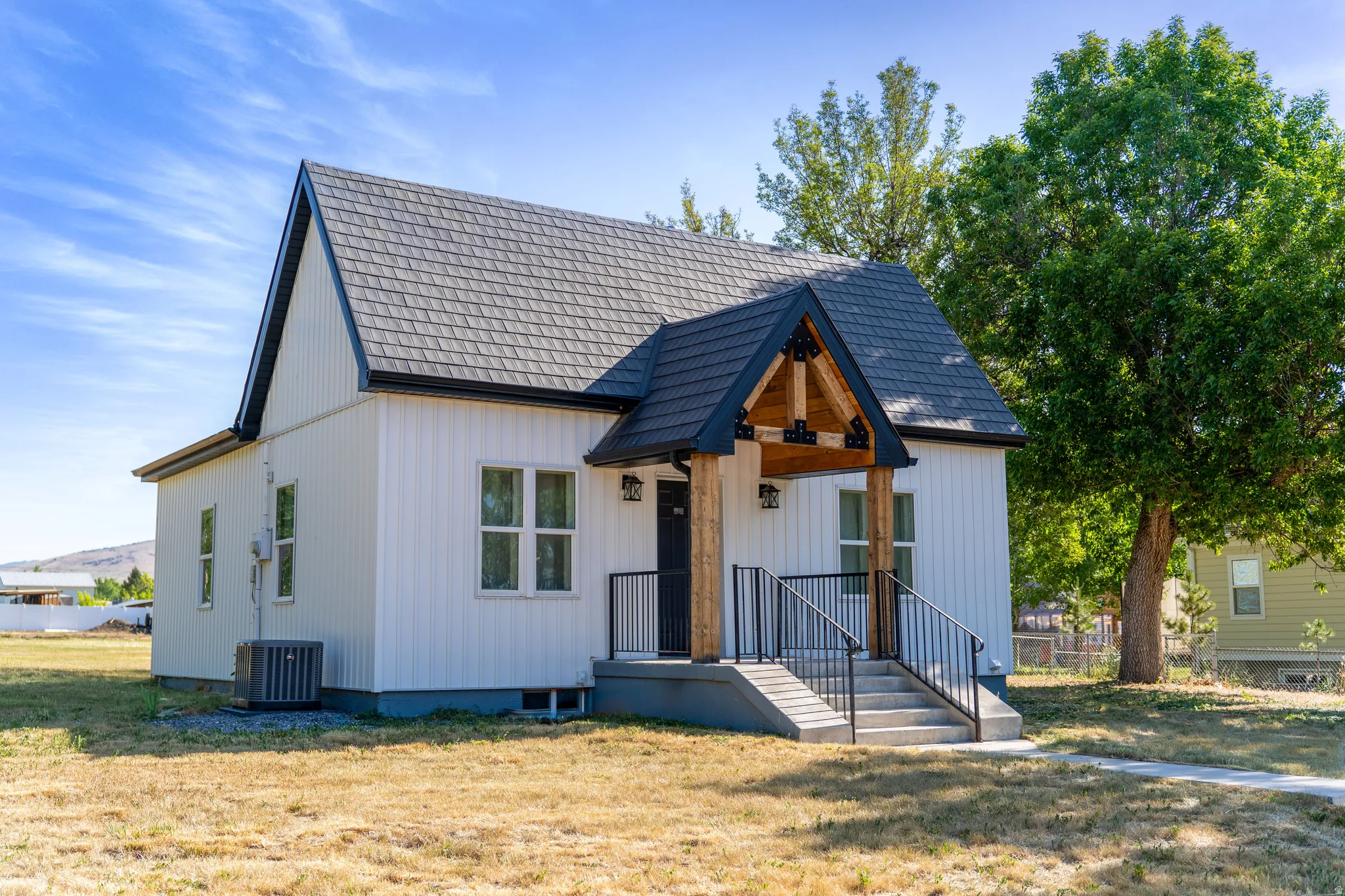 Modern farmhouse style home featuring a front yard and a porch