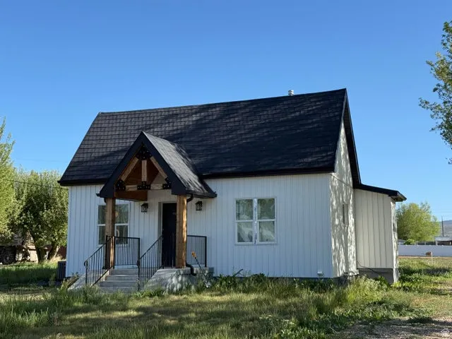 Modern inspired farmhouse with a shingled roof and board and batten siding
