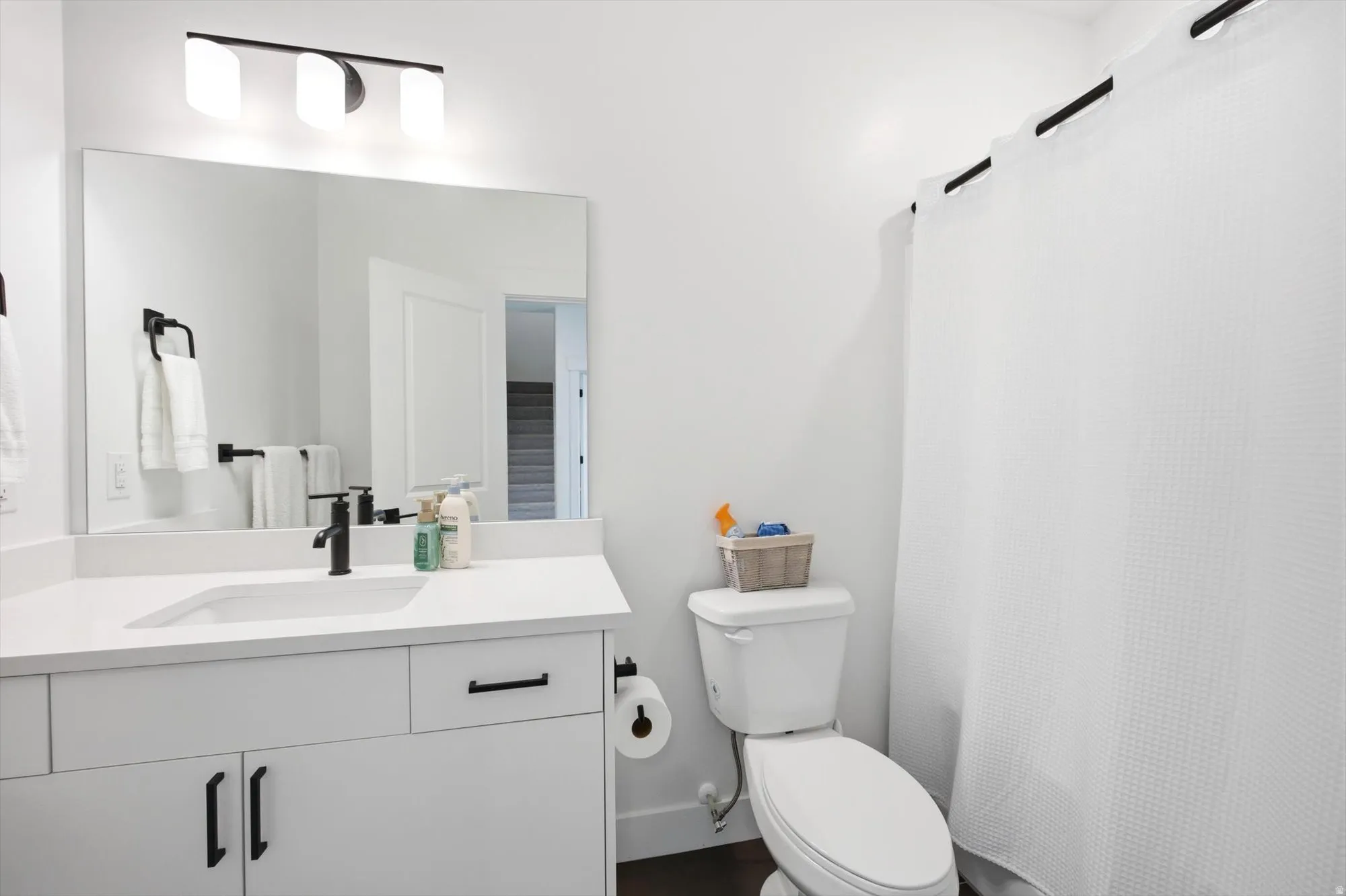 Full bathroom featuring vanity and a shower with shower curtain