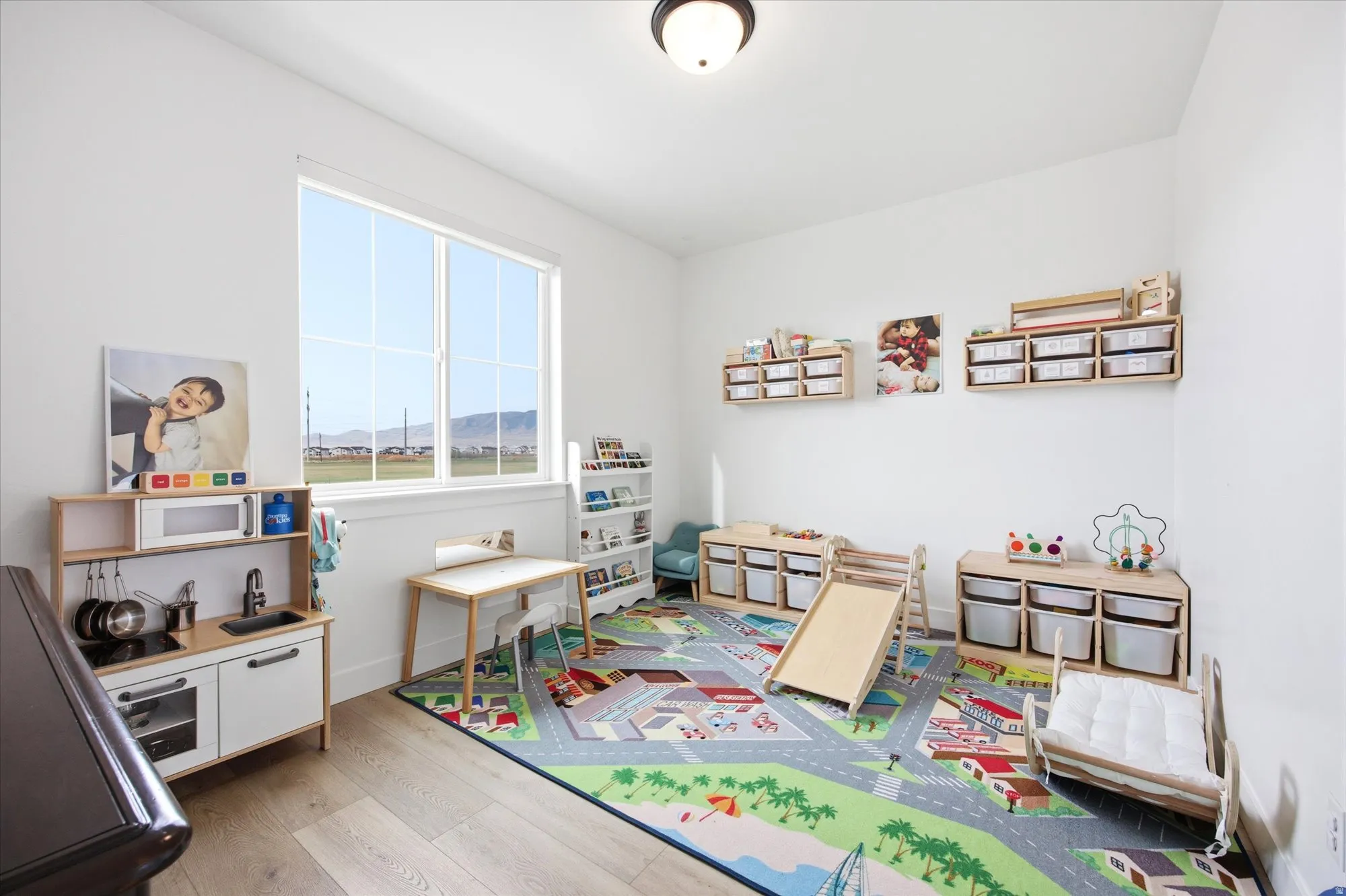 Recreation room featuring light wood-style flooring and baseboards