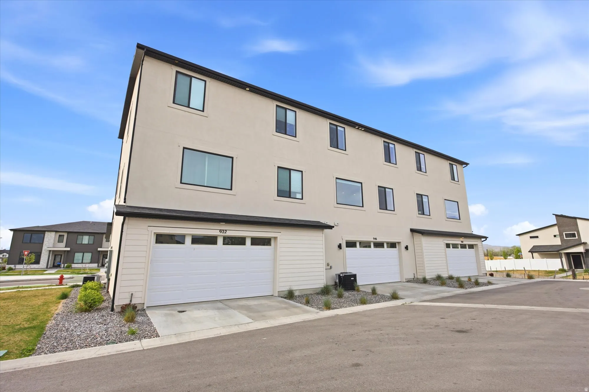 View of front facade featuring an attached garage, stucco siding, and concrete driveway