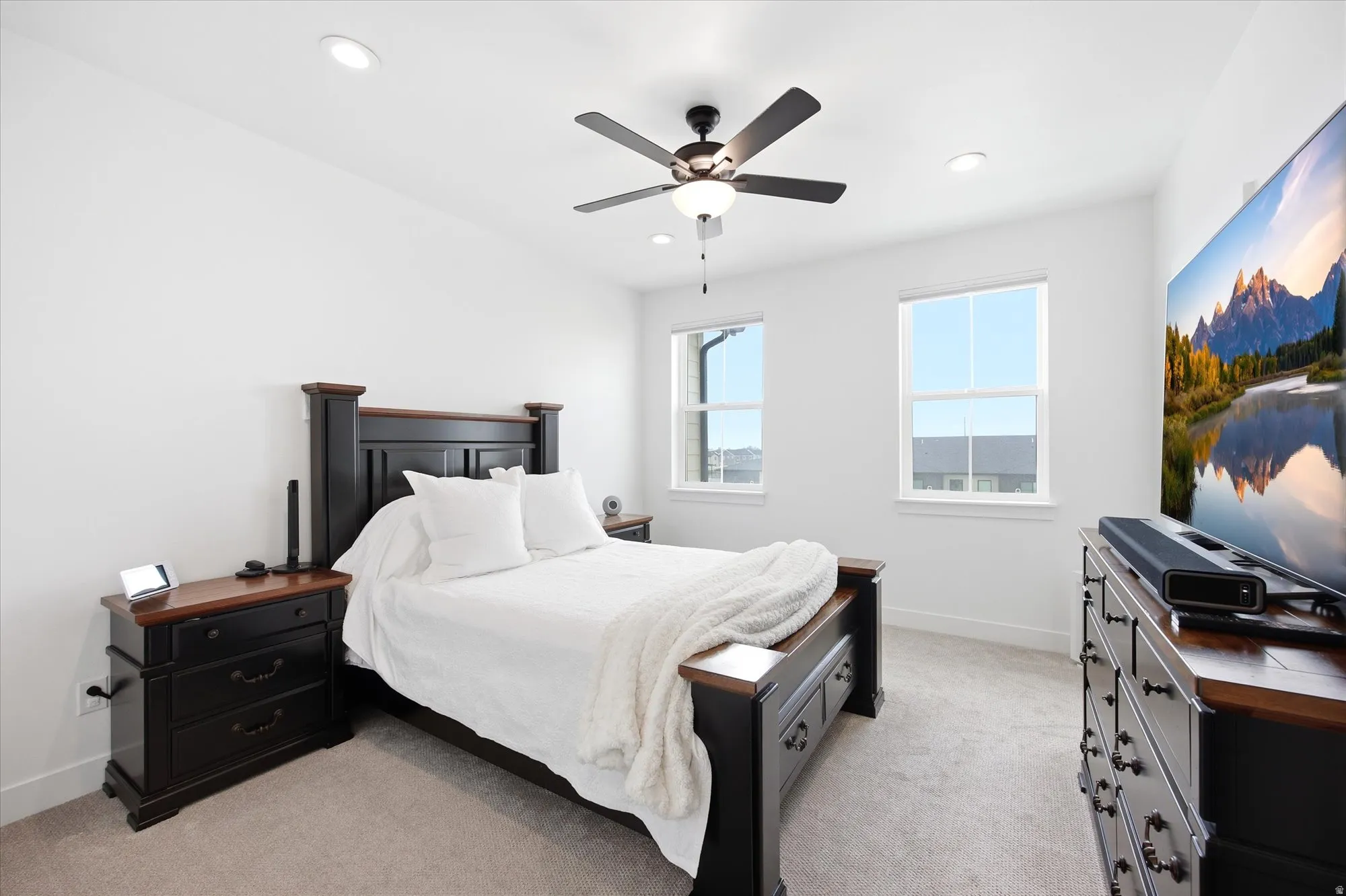 Bedroom featuring light colored carpet, a ceiling fan, and recessed lighting