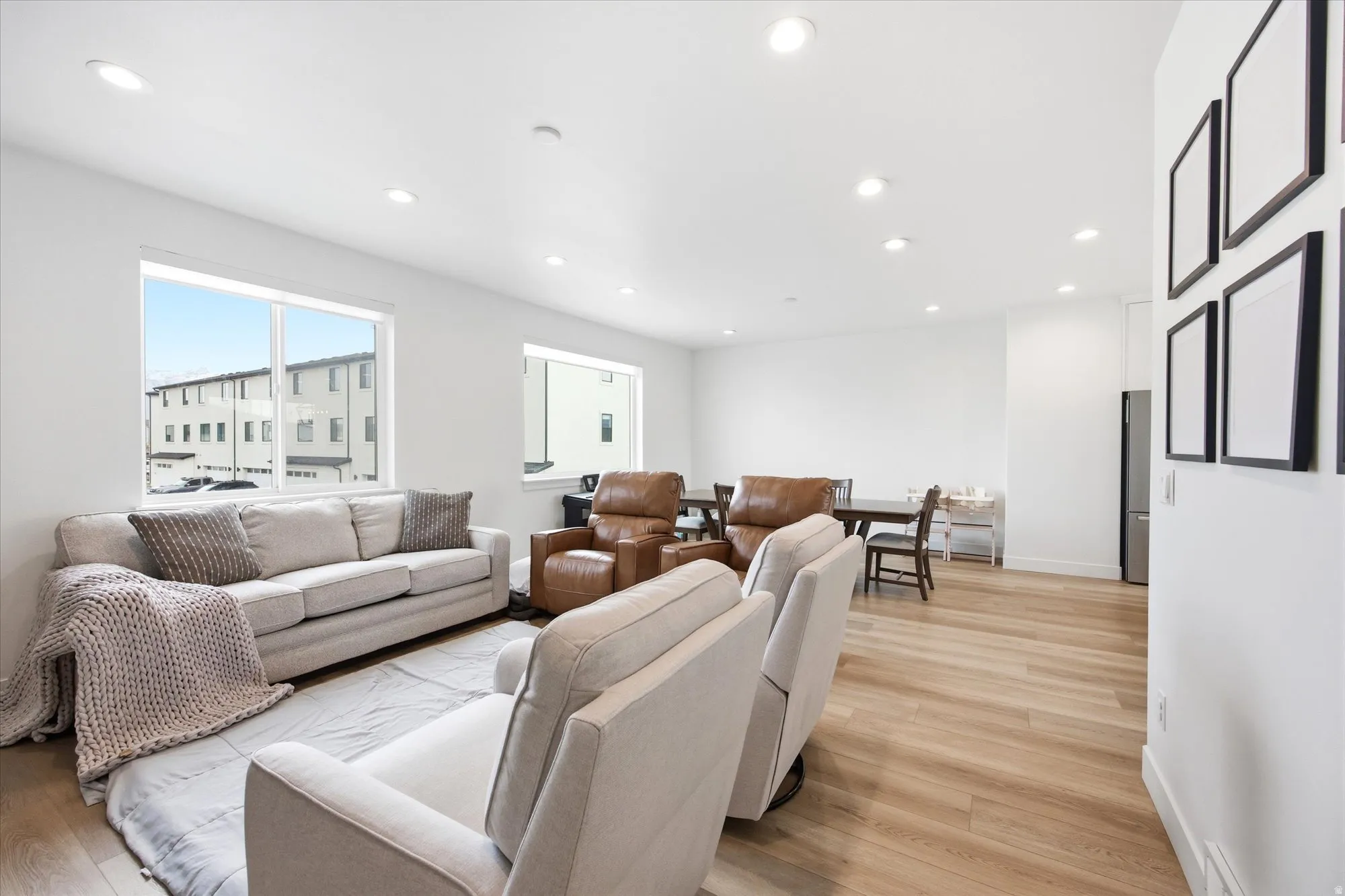 Living area featuring light wood-style flooring and recessed lighting