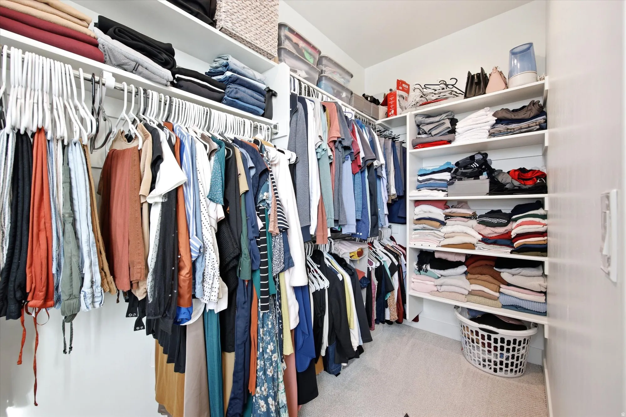 Walk in closet featuring light colored carpet