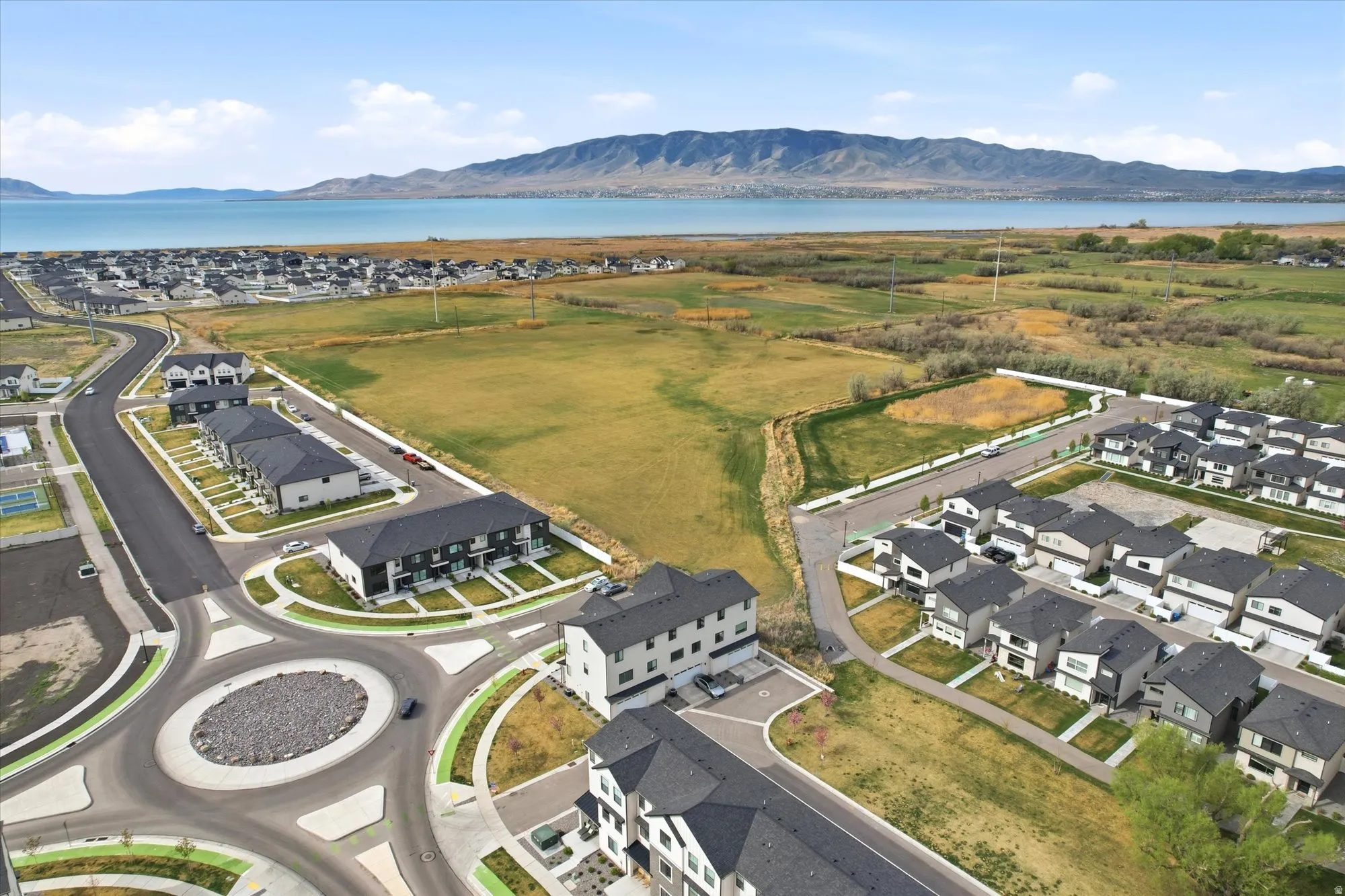 Aerial view of property's location featuring nearby suburban area and a water and mountain view