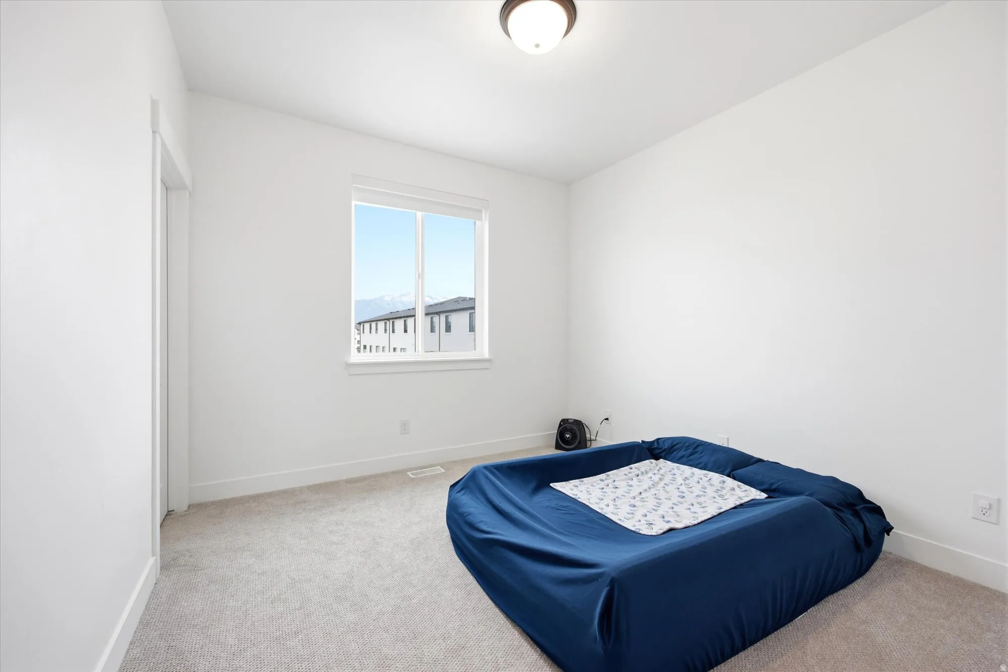 Bedroom with carpet flooring and baseboards