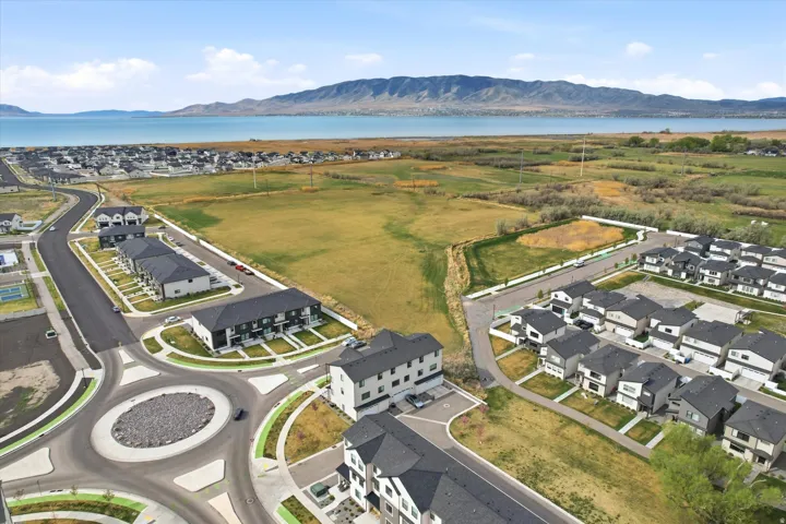 Aerial view of property's location featuring nearby suburban area and a water and mountain view