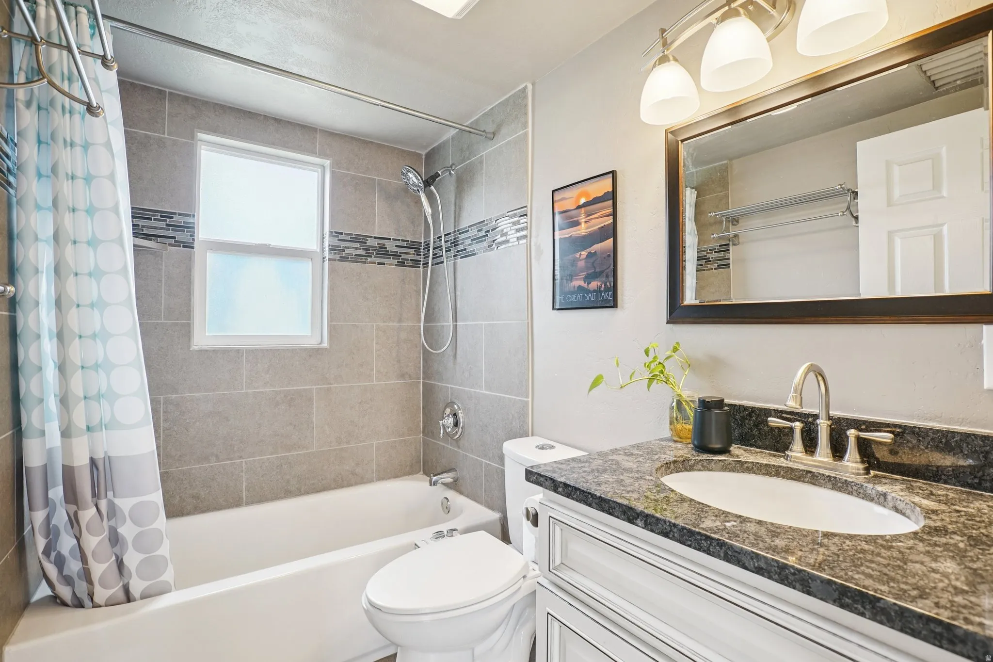 Bathroom with vanity and shower / bath combination with curtain
