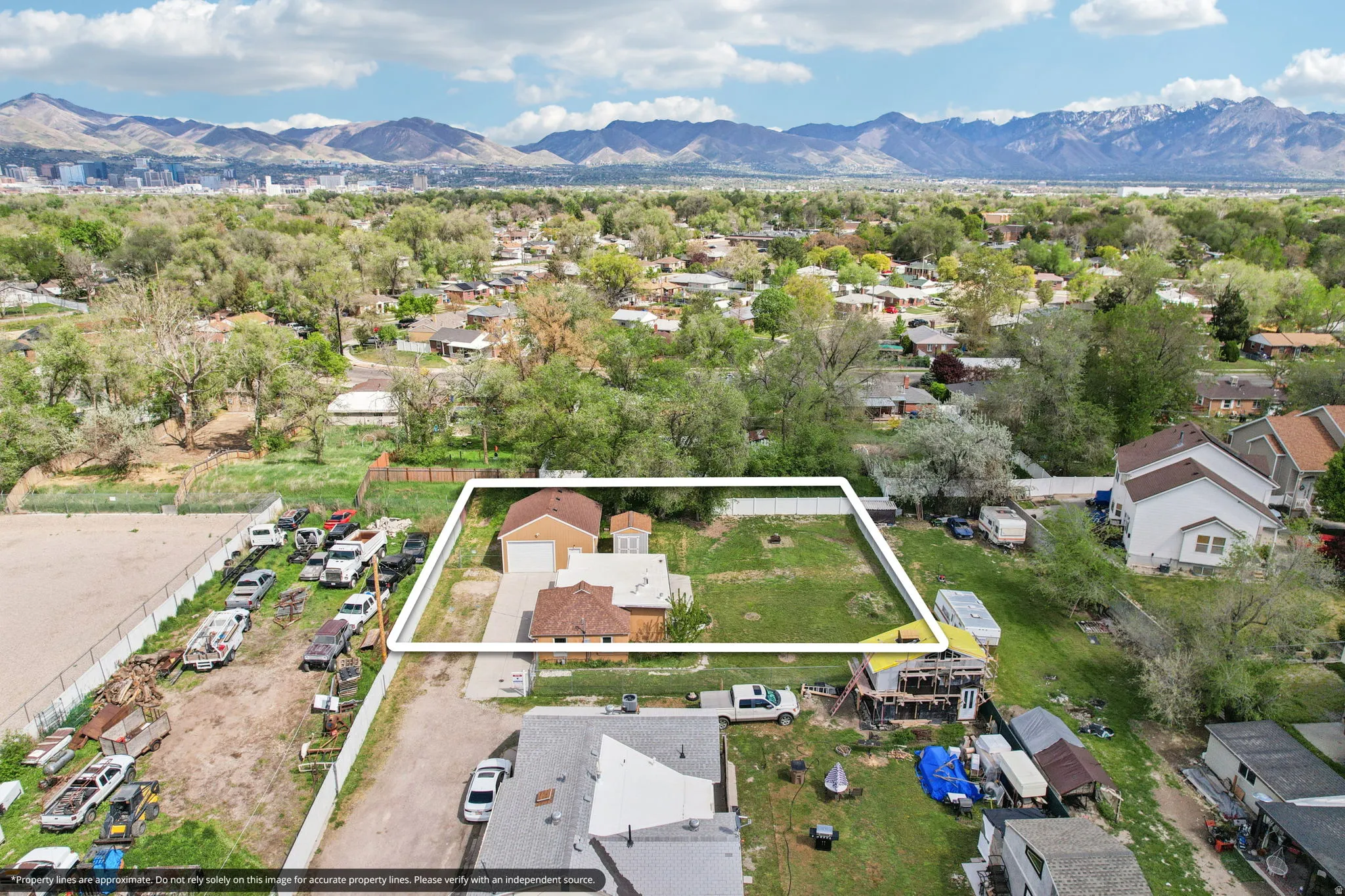 Aerial perspective of suburban area featuring property boundaries highlighted and mountains