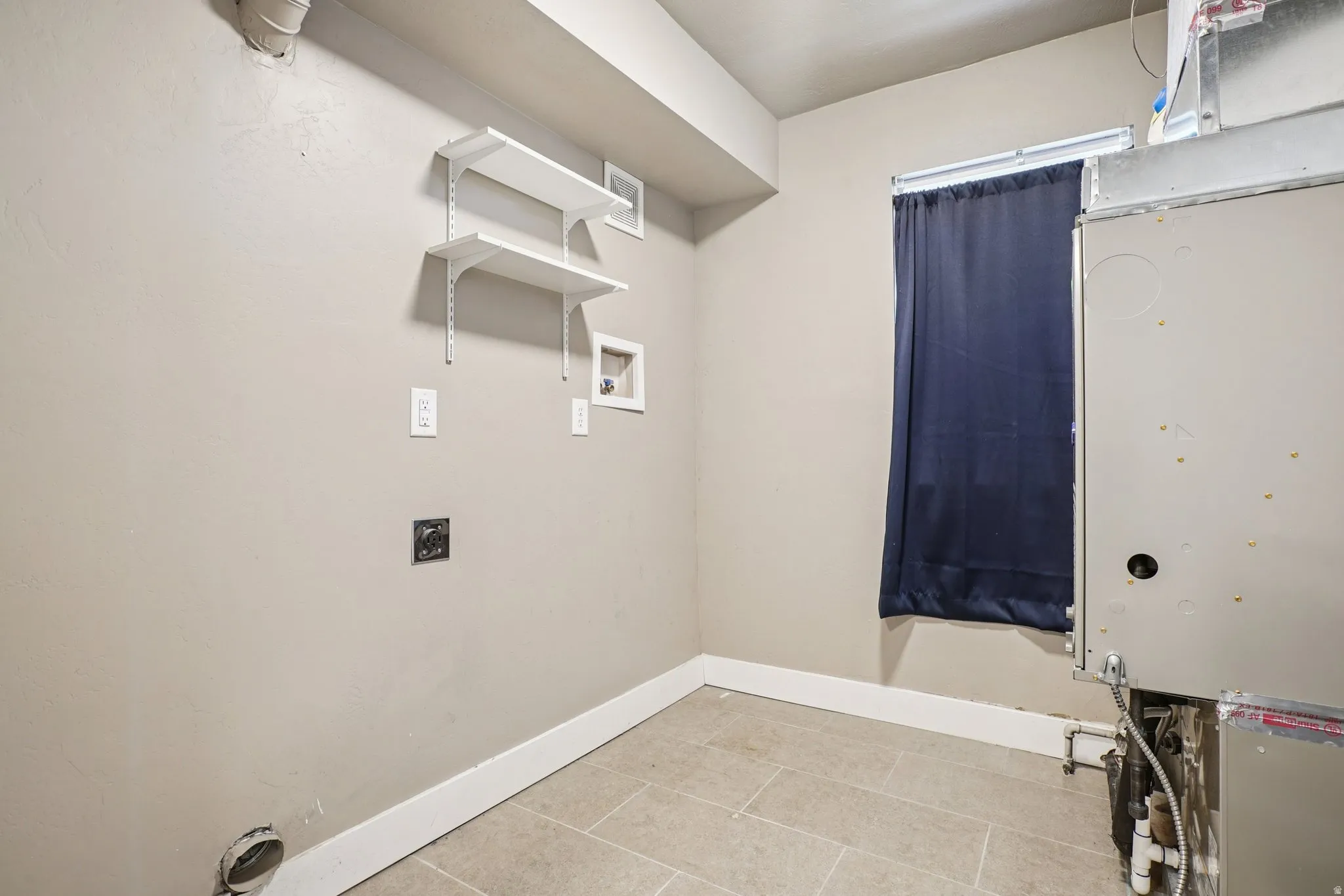 Laundry area with hookup for a washing machine and electric dryer hookup