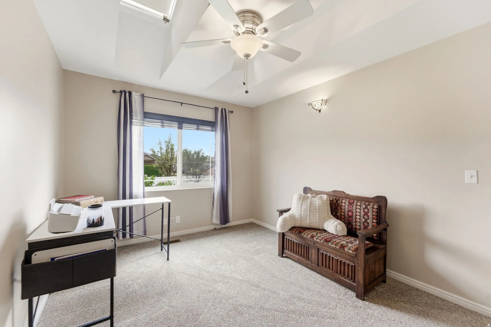 Home office with ceiling fan and light carpet