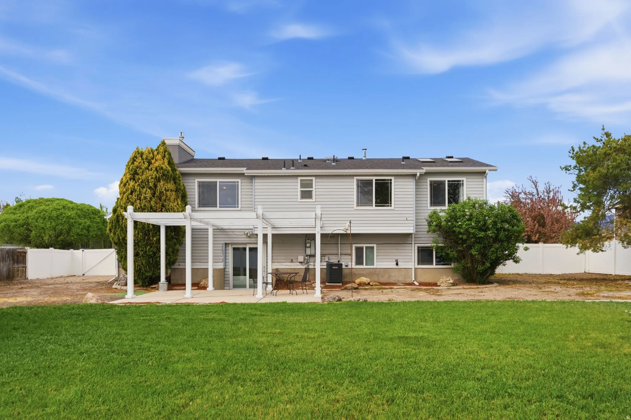 Back of house with a pergola, a fenced backyard, and a patio