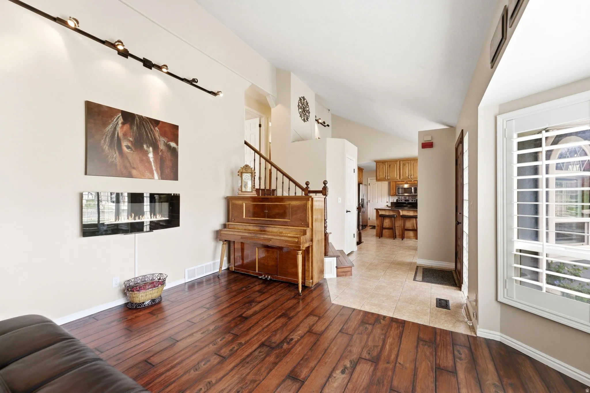 Sitting room featuring light wood-type flooring and lofted ceiling