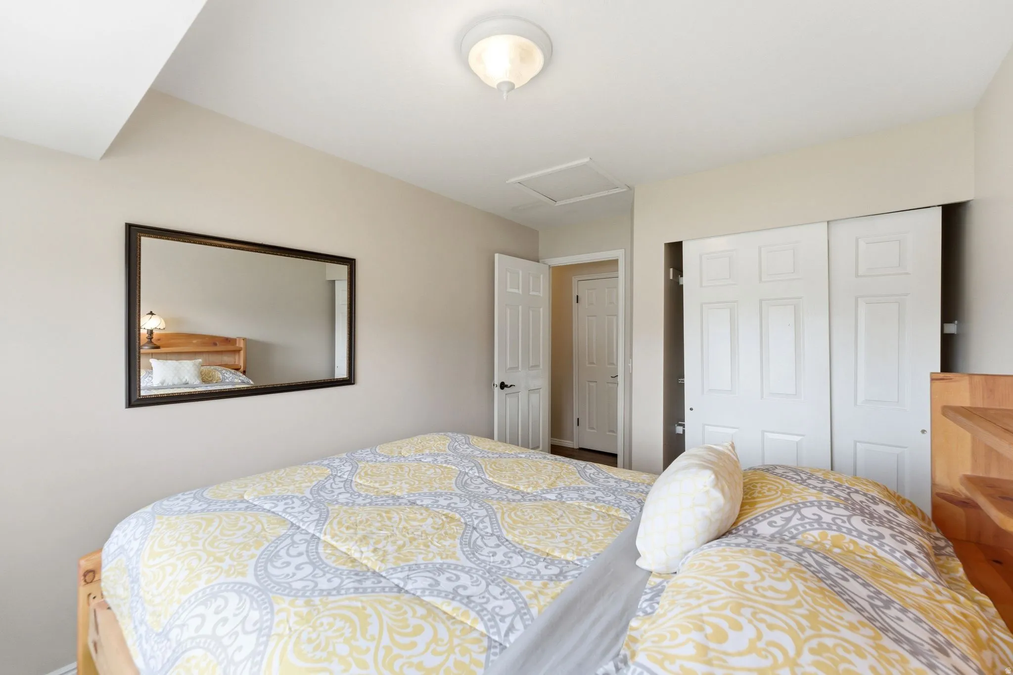 Bedroom with attic access and a closet