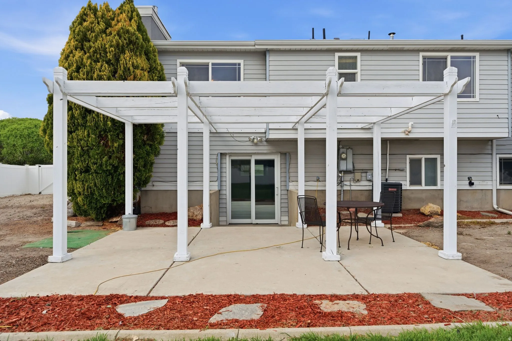 Back of property featuring a pergola, a patio area, and outdoor dining area
