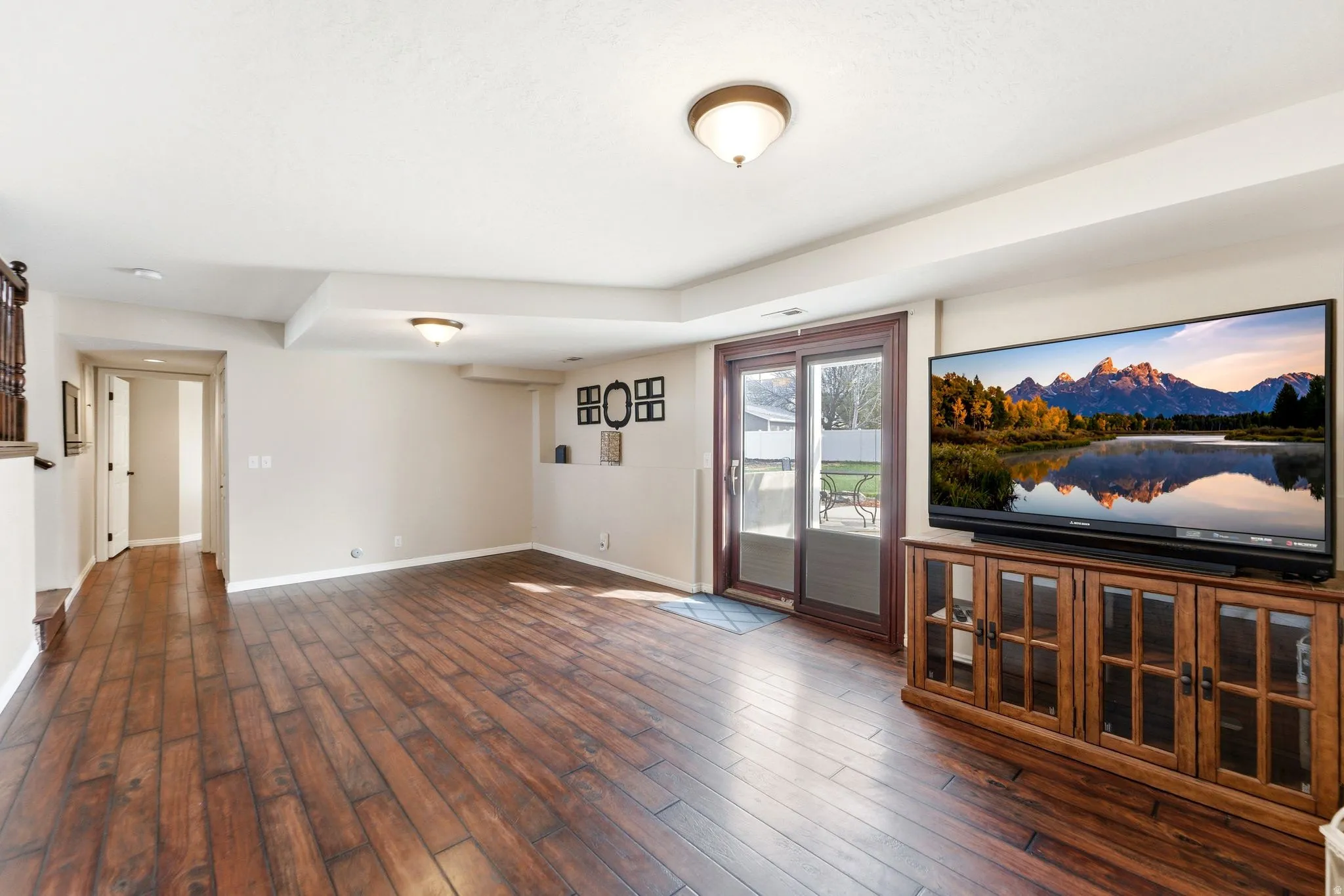 Unfurnished living room with baseboards and dark wood finished floors