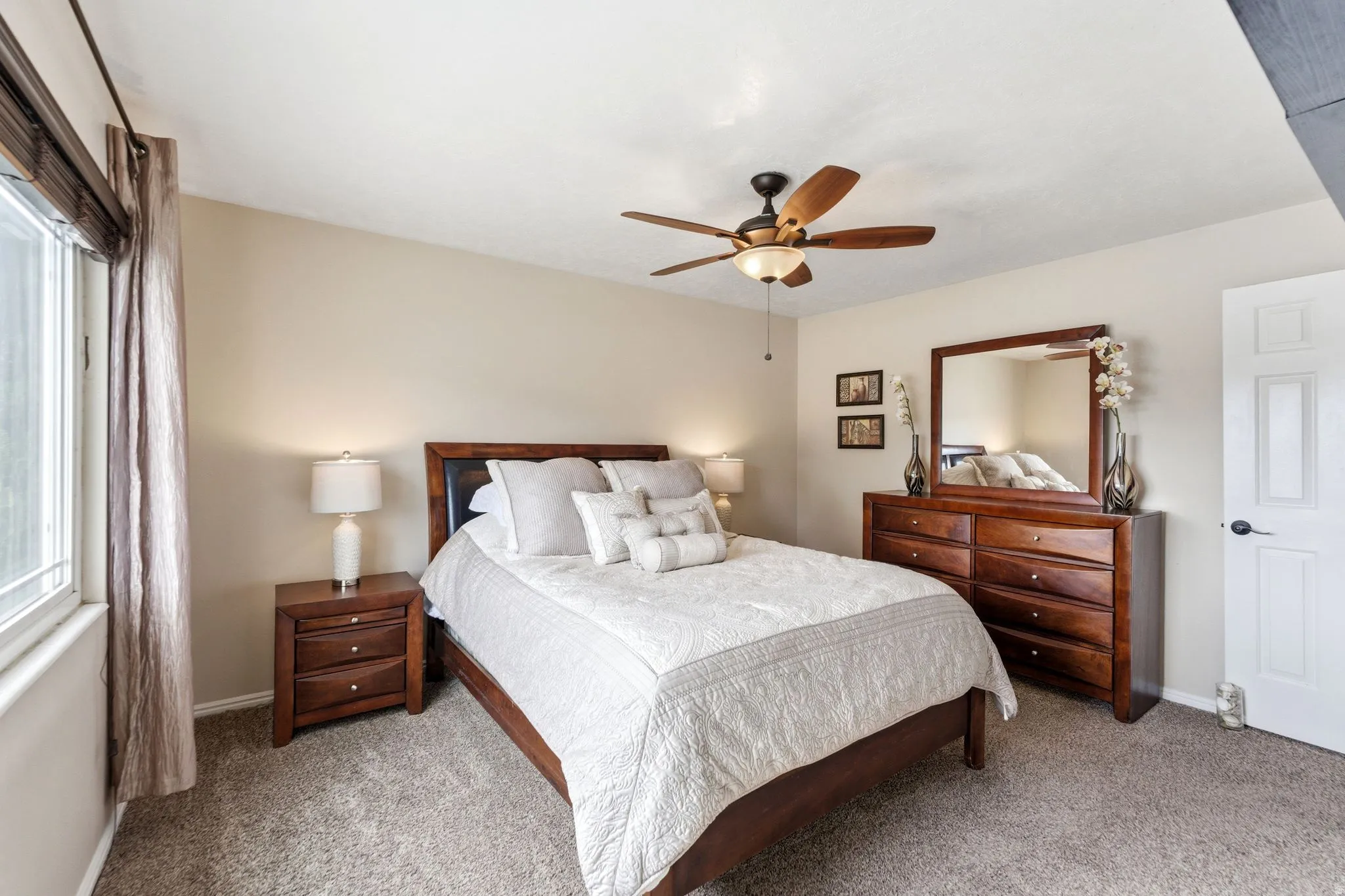Bedroom featuring ceiling fan and light colored carpet