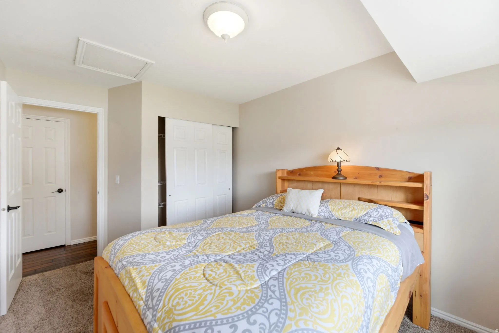 Bedroom with dark carpet and a closet