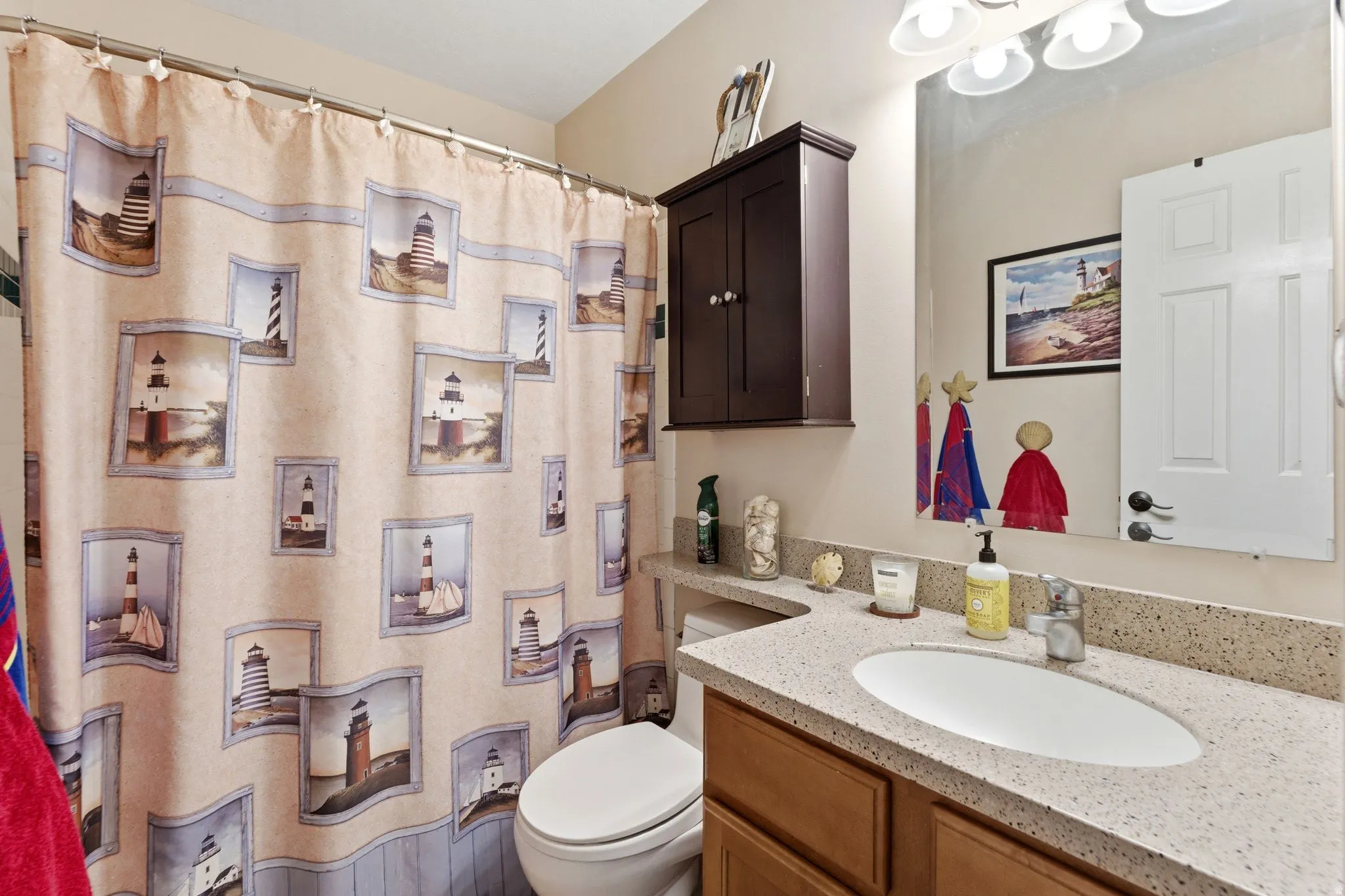 Bathroom with a shower with shower curtain and vanity
