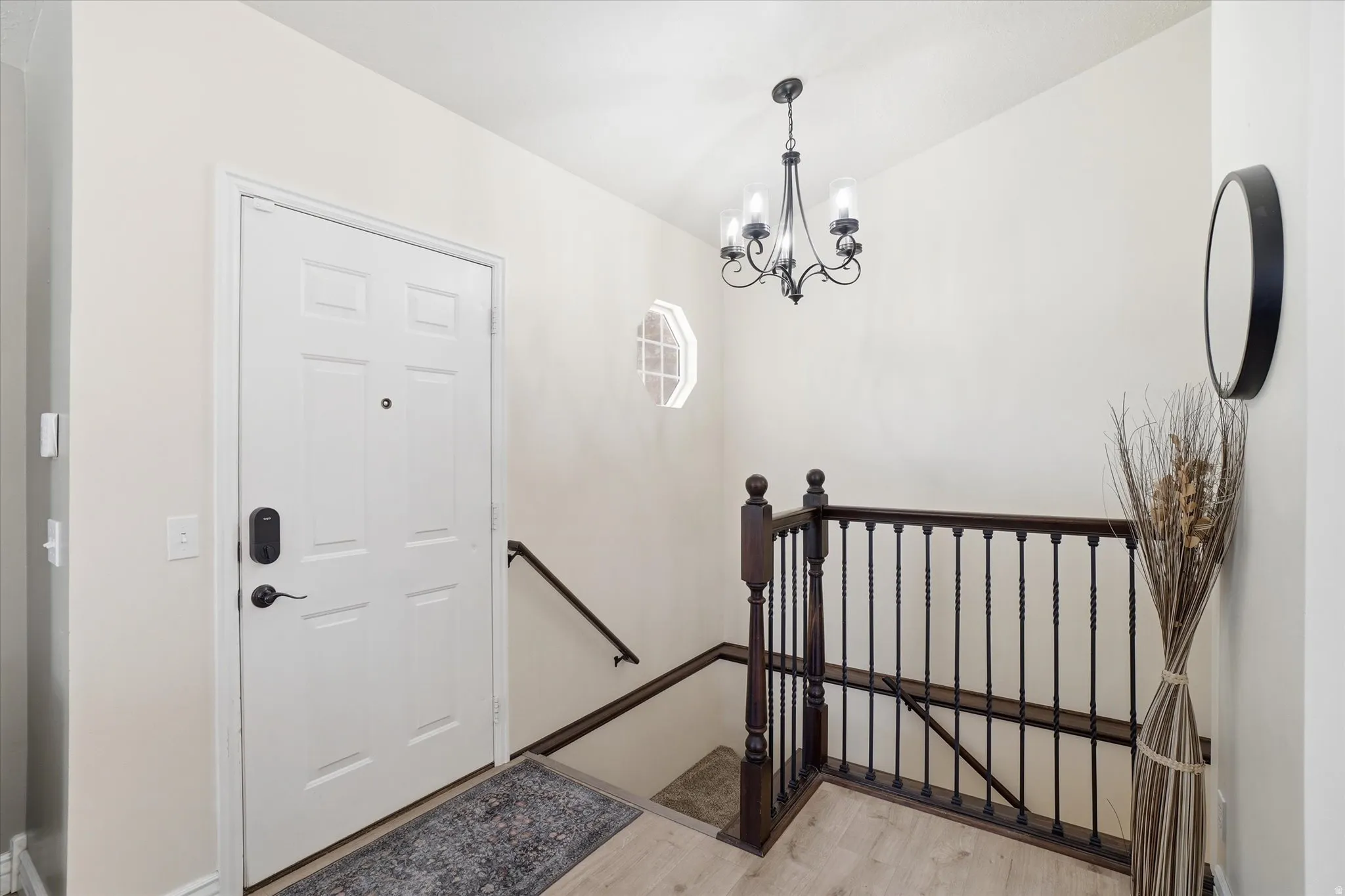 Entrance foyer featuring light wood-style flooring and a chandelier