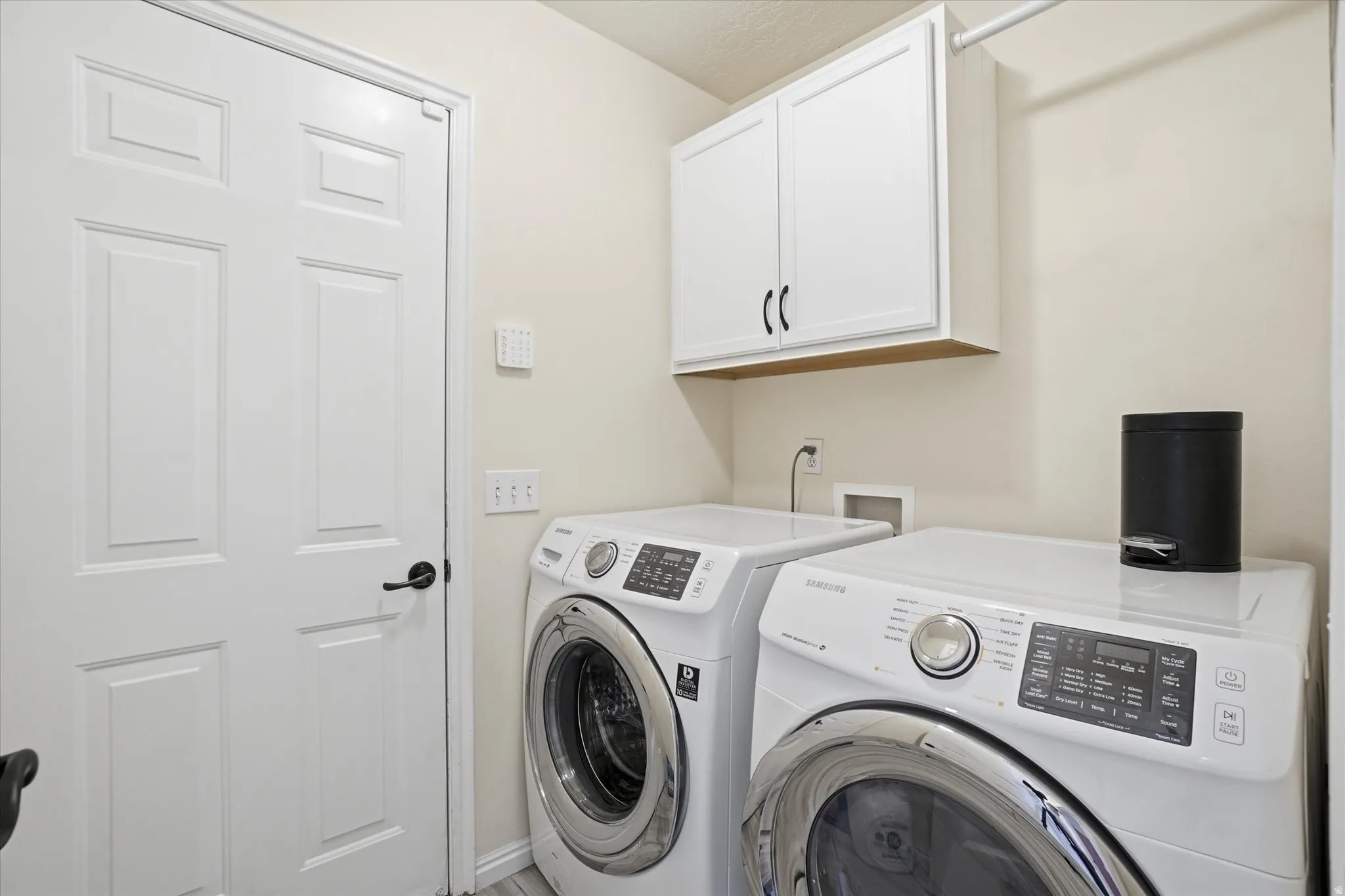 Laundry area with cabinet space and washer and dryer