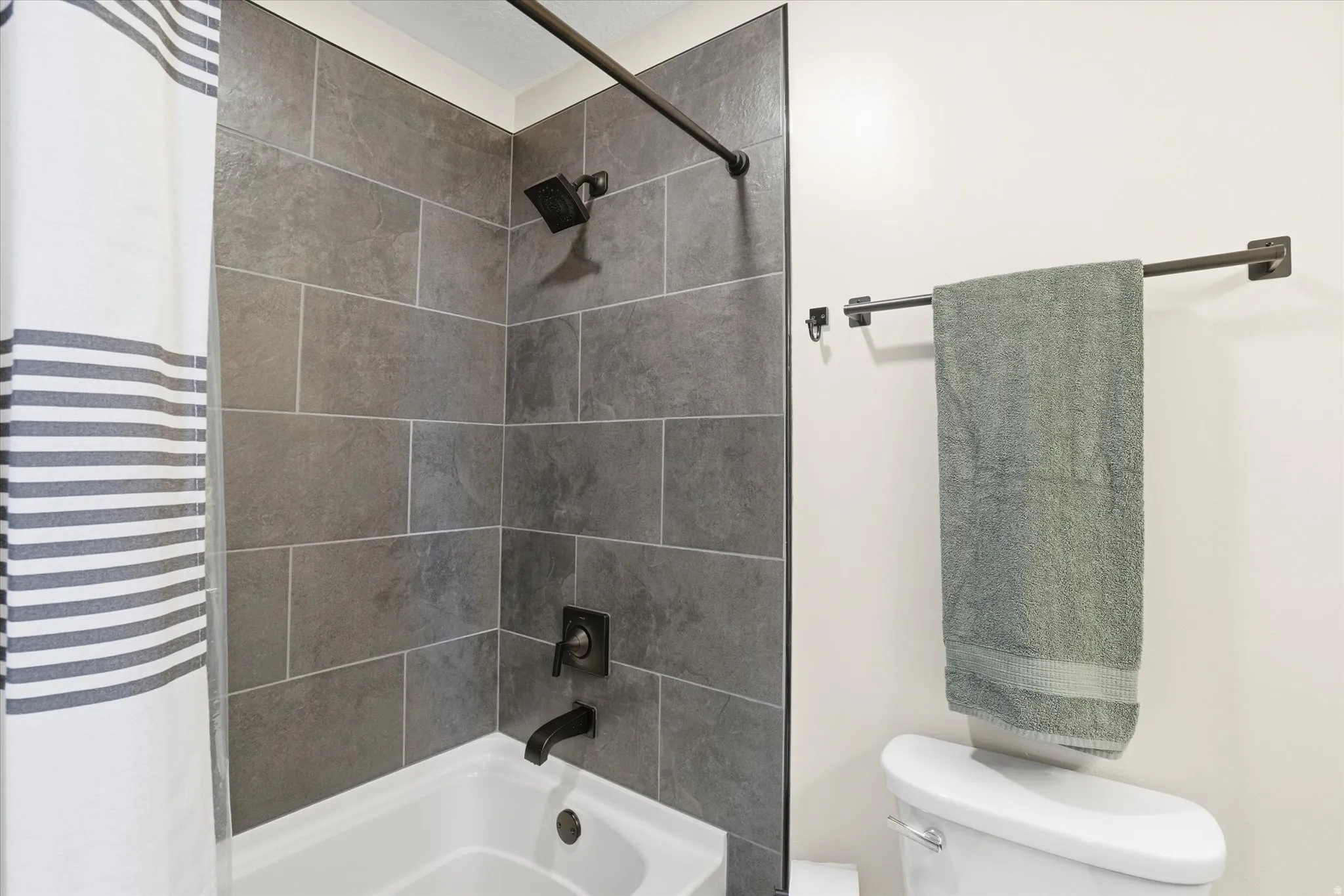 Bathroom featuring toilet and shower / tub combo