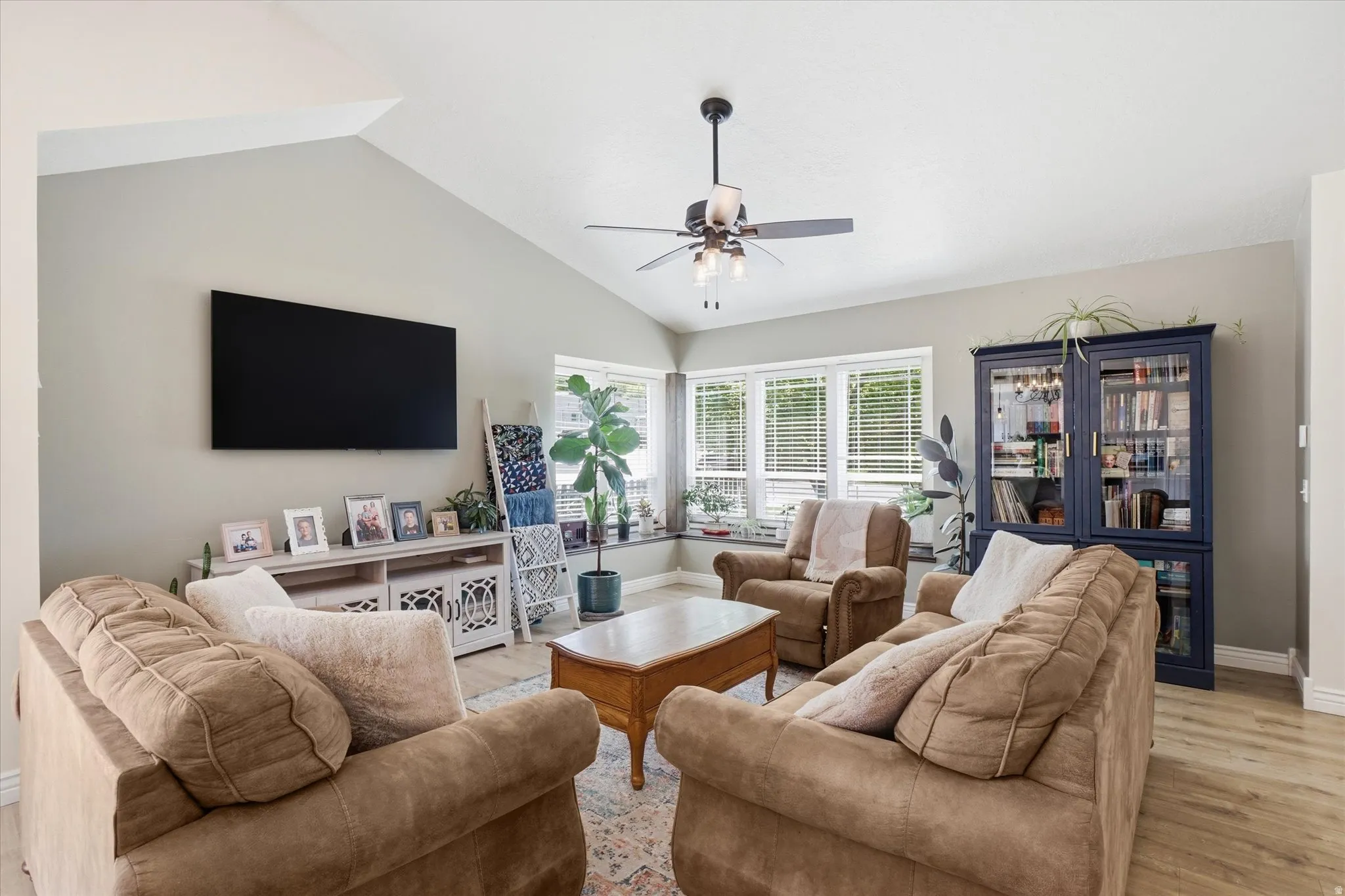 Living area has vaulted ceiling, LVP flooring and natural light