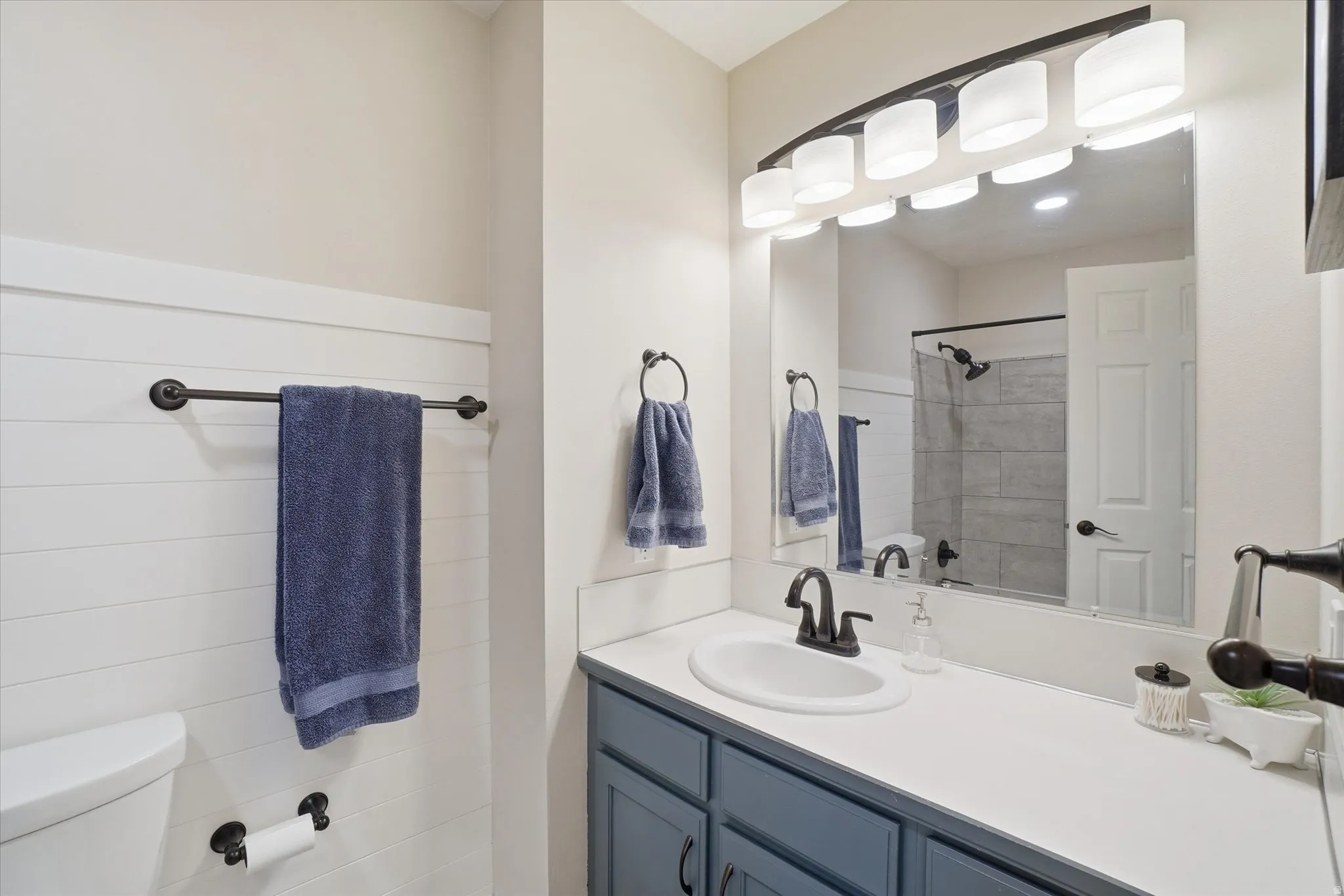Bathroom featuring vanity and a shower