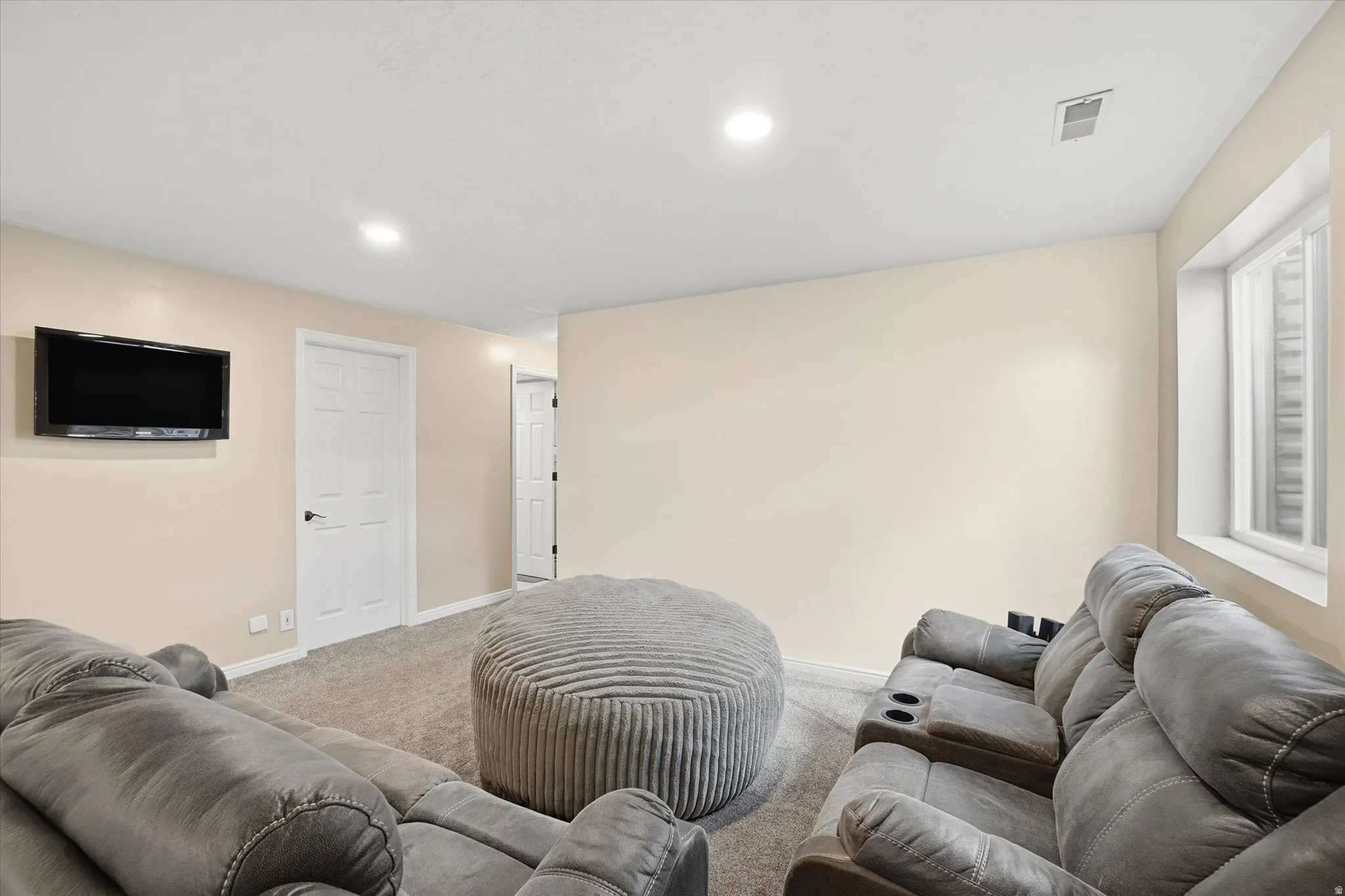 Living room with carpet flooring and recessed lighting