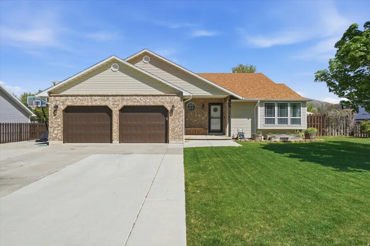 Ranch-style house with an attached garage, concrete driveway, and brick siding