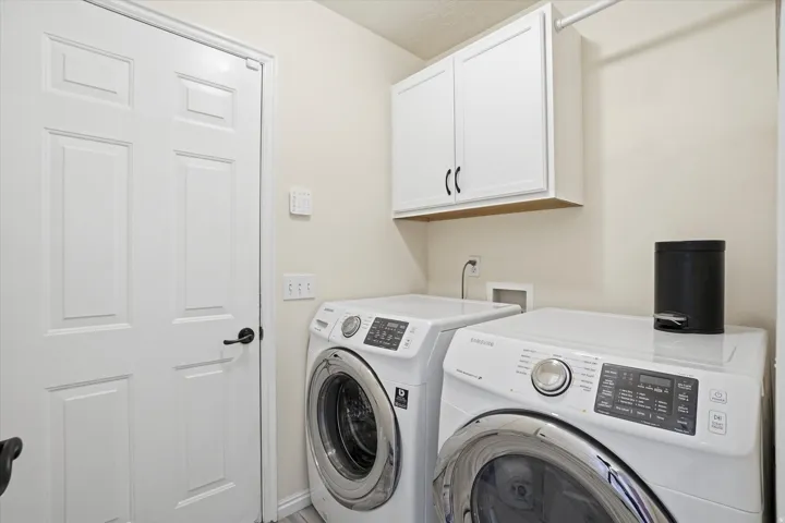 Laundry area with cabinet space and washer and dryer