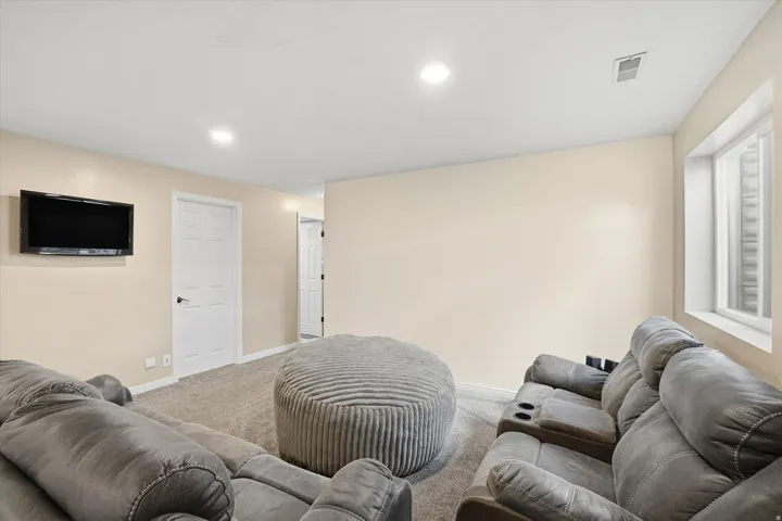 Living room with carpet flooring and recessed lighting