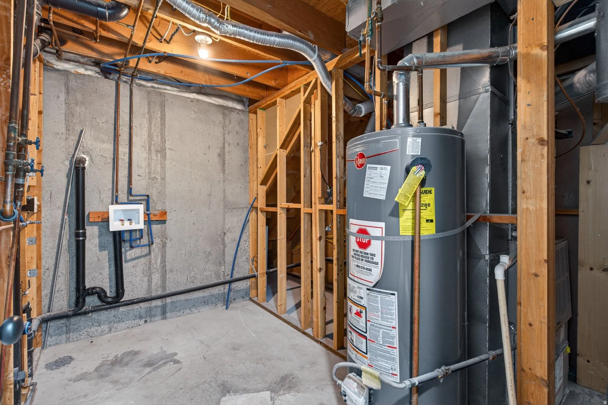 Utility room featuring water heater