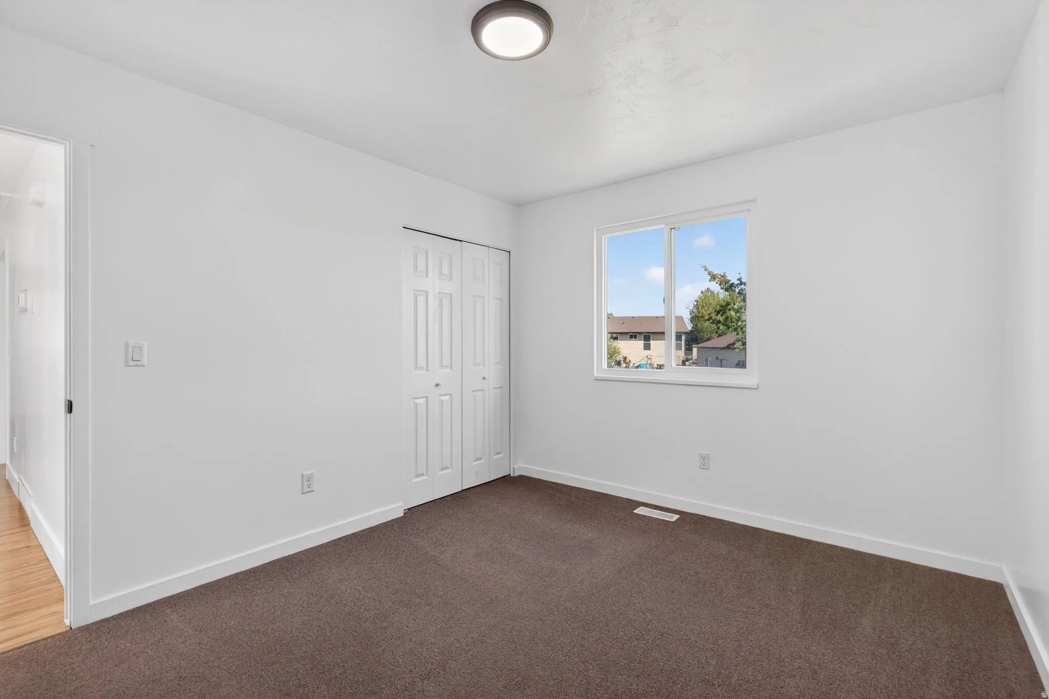Unfurnished bedroom featuring a closet and carpet flooring