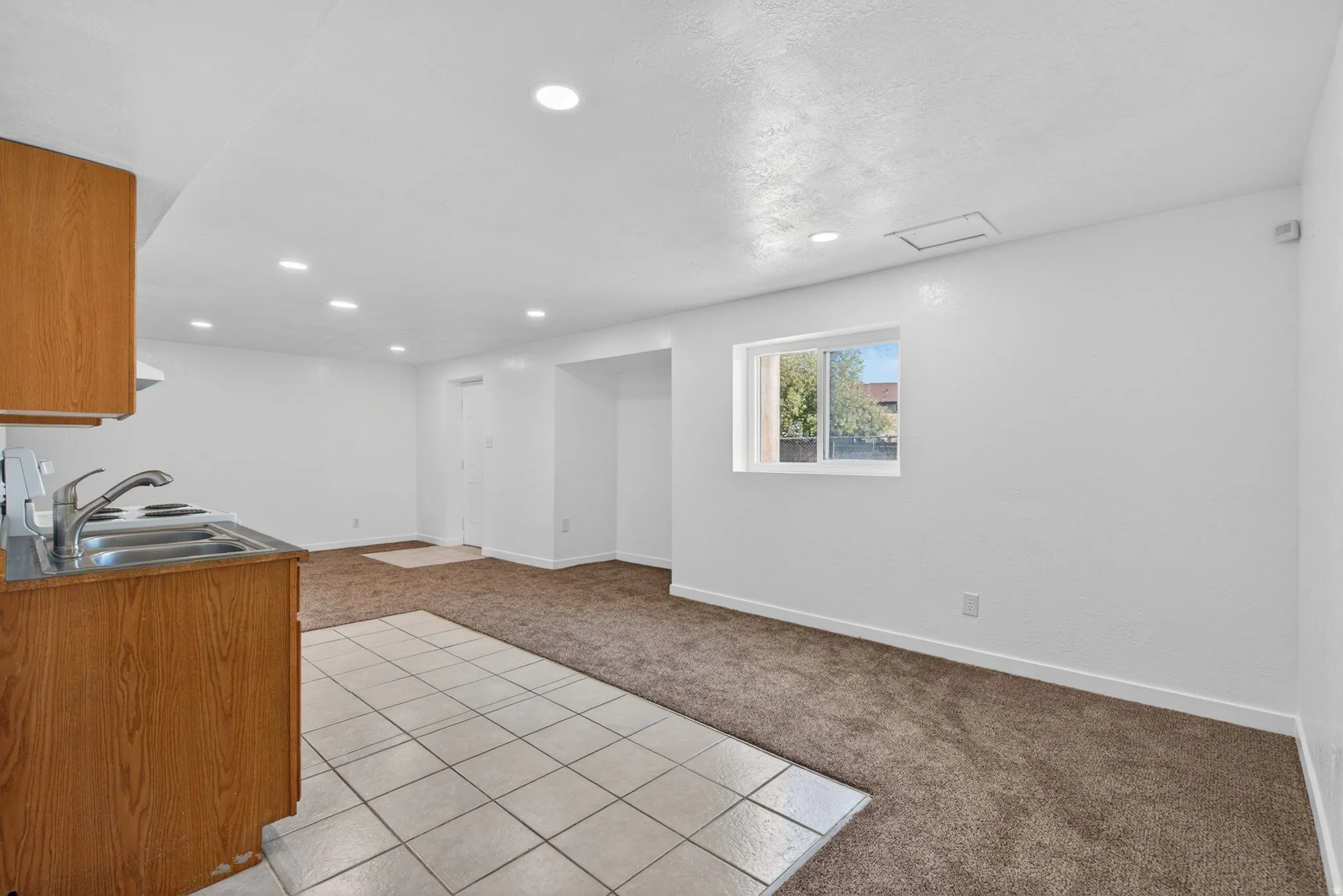 Basement with light carpet and recessed lighting
