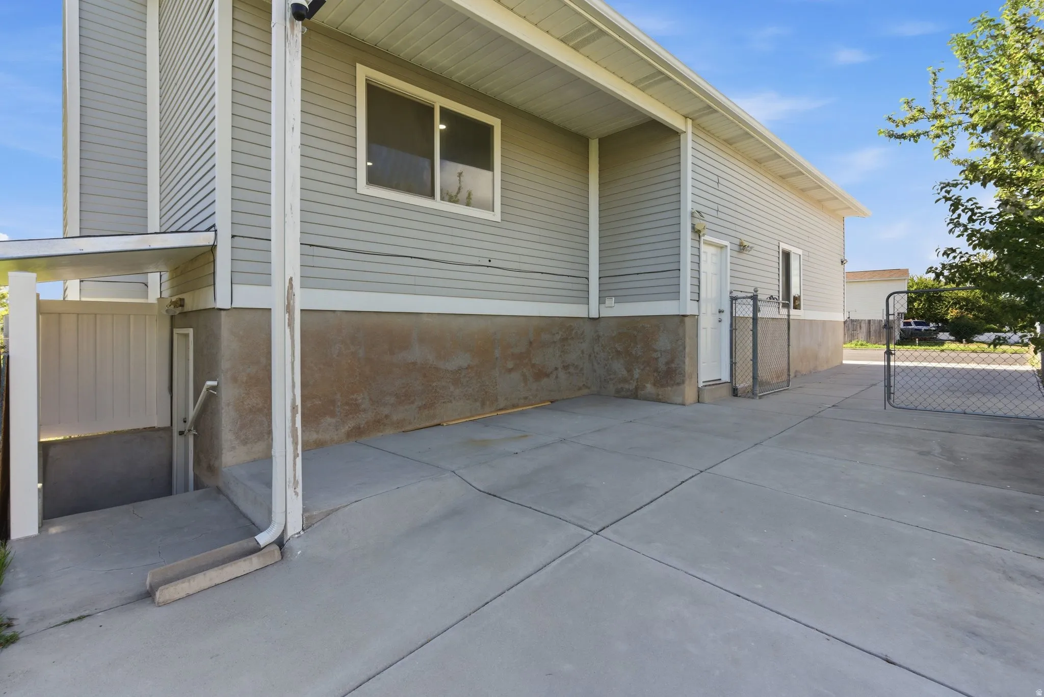 View of property exterior with a gate