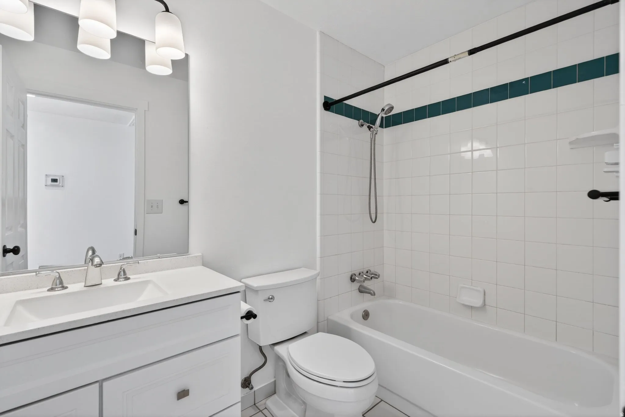 Full bath featuring vanity, shower / washtub combination, and tile patterned flooring