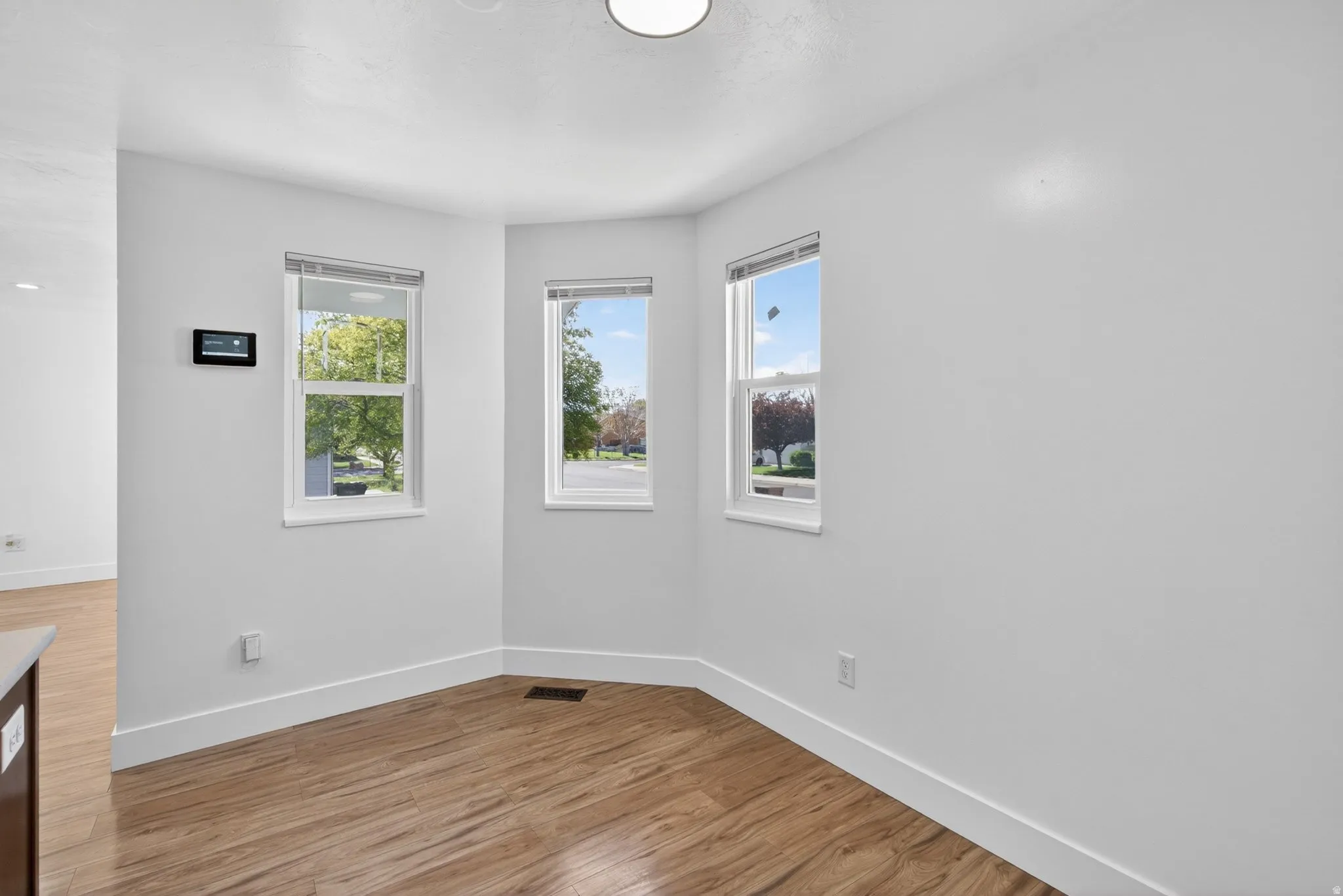 Unfurnished room featuring light wood-style floors and plenty of natural light