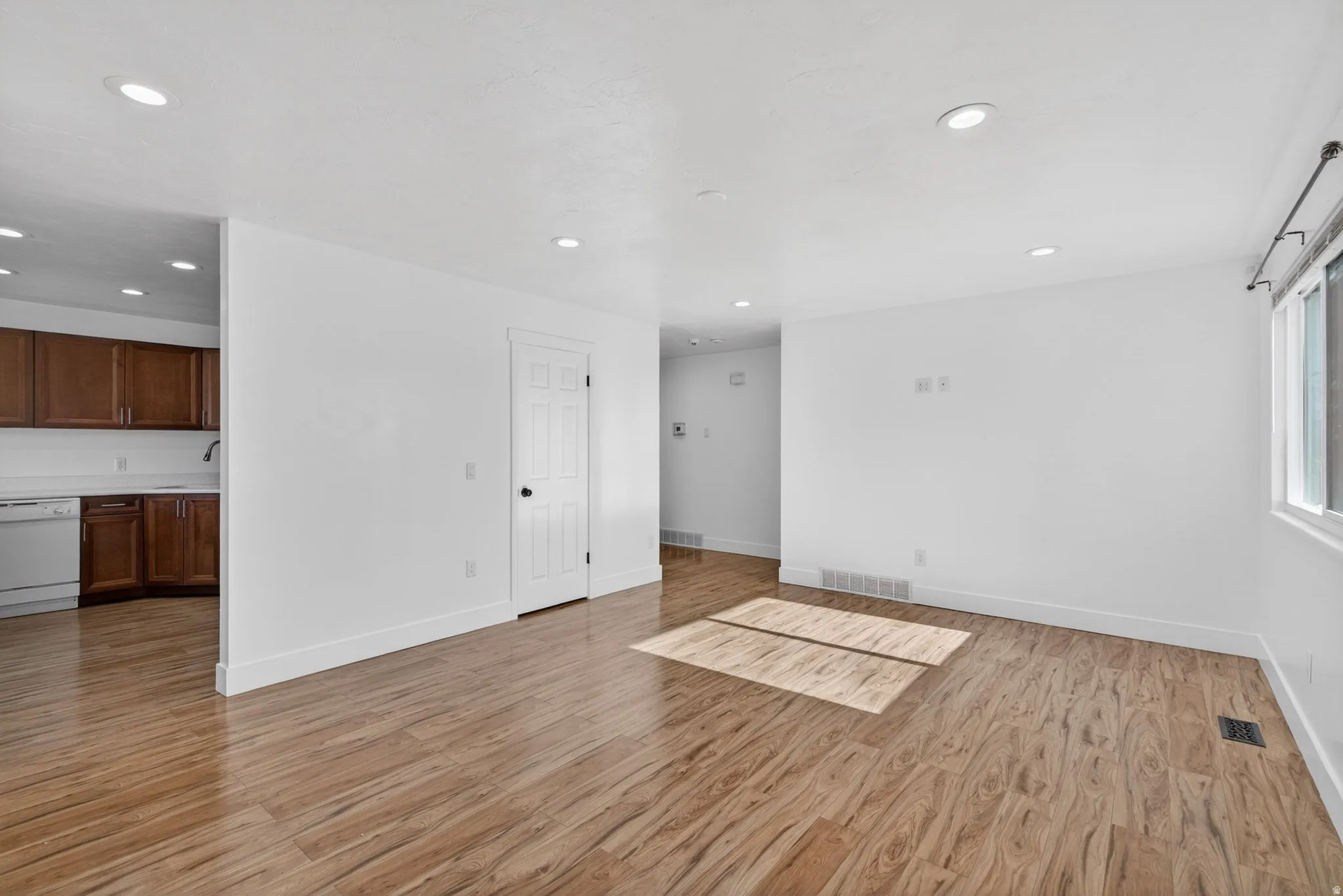 Unfurnished living room with light wood-style flooring and recessed lighting