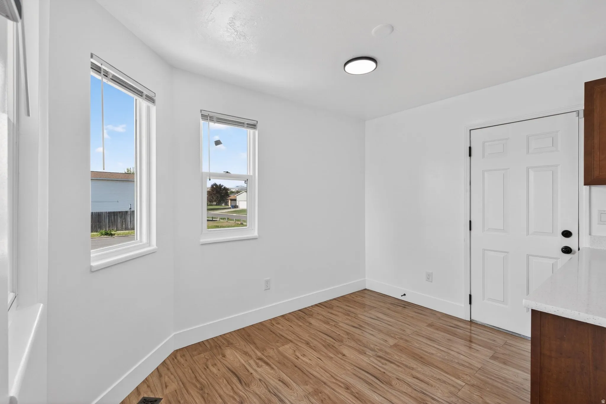 Unfurnished room featuring baseboards and light wood finished floors