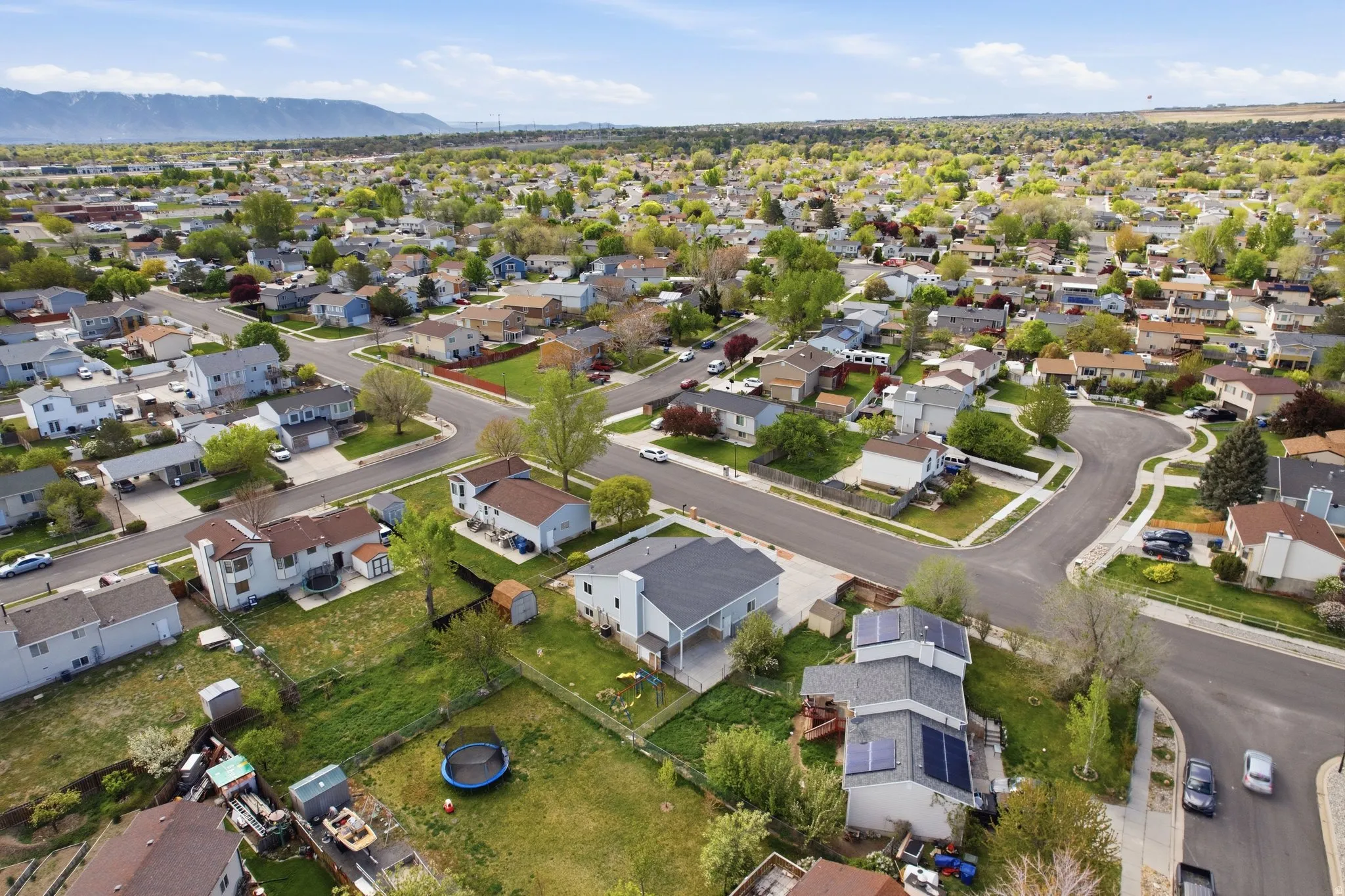 Aerial view of property's location featuring nearby suburban area and a mountain backdrop