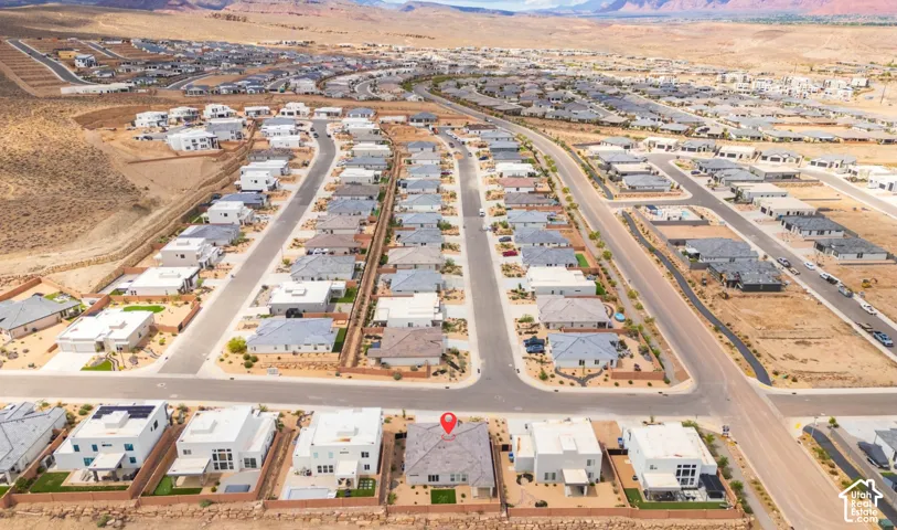 New construction residential development in a desert landscape with paved streets and established homes