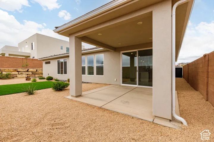 Covered patio with concrete flooring, sliding glass door, and recessed lighting