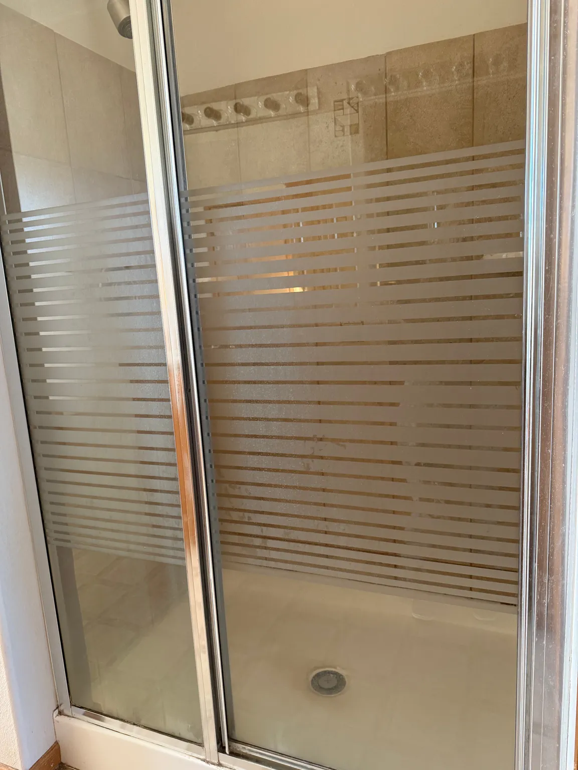 Full bathroom featuring a shower stall